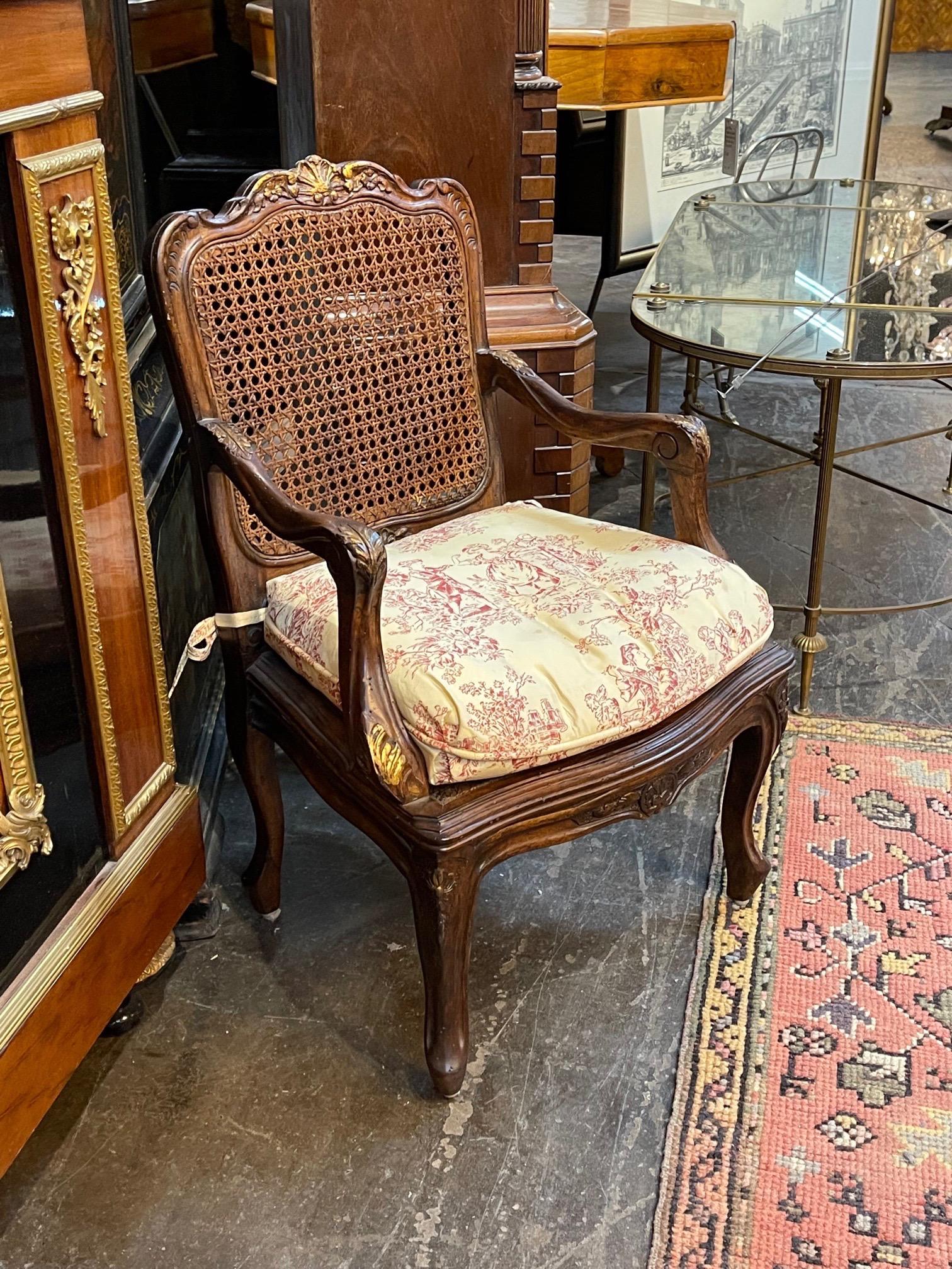 Beautiful 19th century French Provincial carved oak child's chairs. The piece has a cane seat and back and toile cushion. Simply adorable!