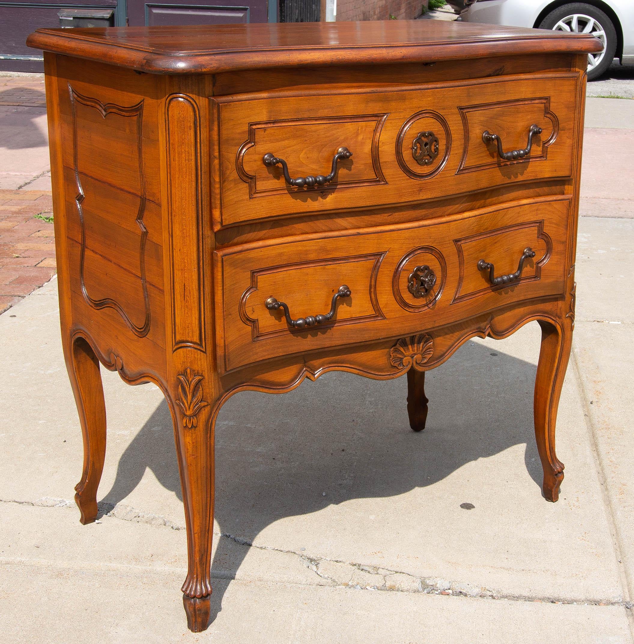 French Provincial carved solid cherry commode. Hand cut dovetail construction. Brass hardware. Locking drawers with key.
     