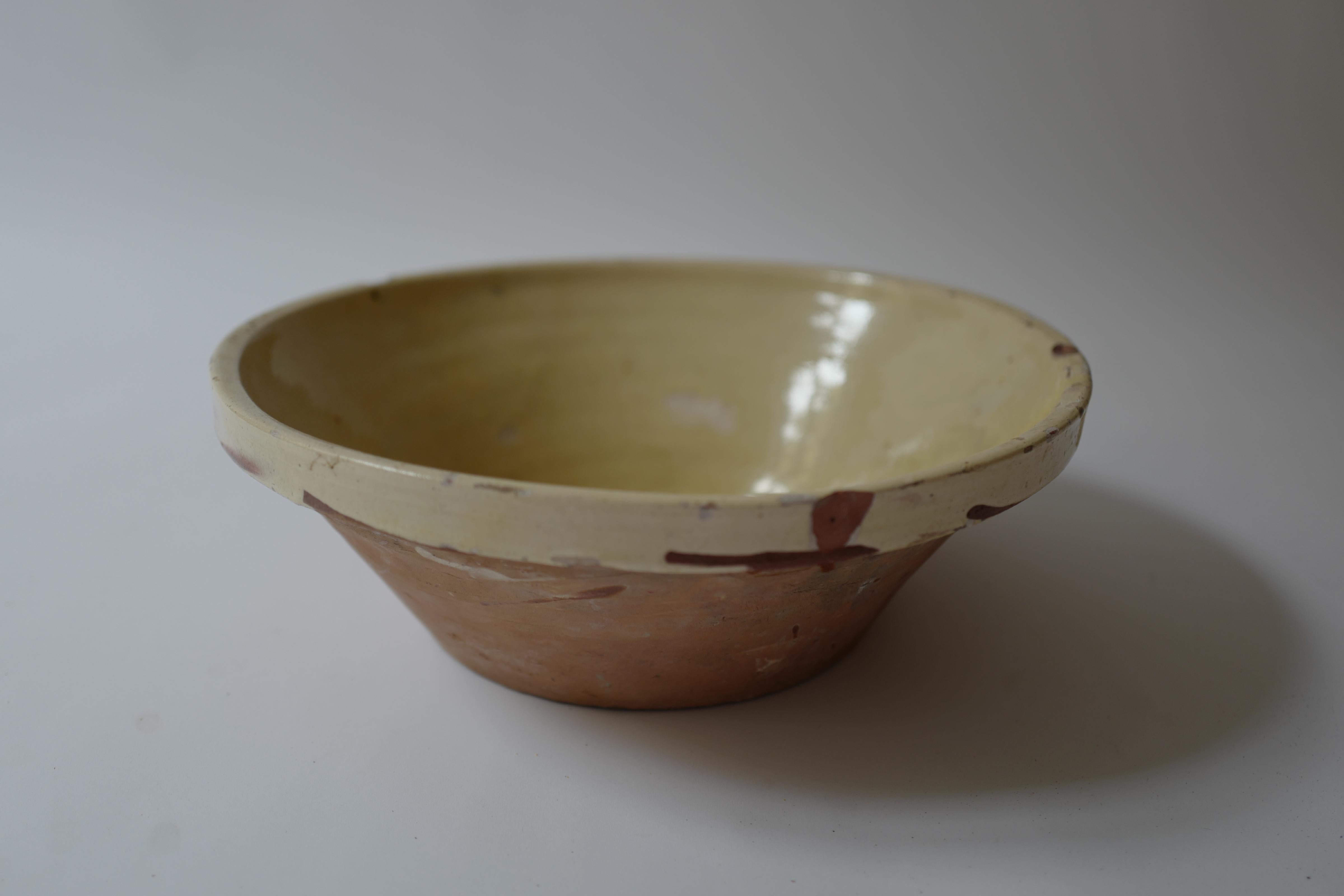 Antique French Provincial Tian bowl in light yellow. Beautiful time worn patina. Circa early 19th century found in Provence, France. These were used for preparation as mixing bowls made of earthenware. The tian style bowl is originally from