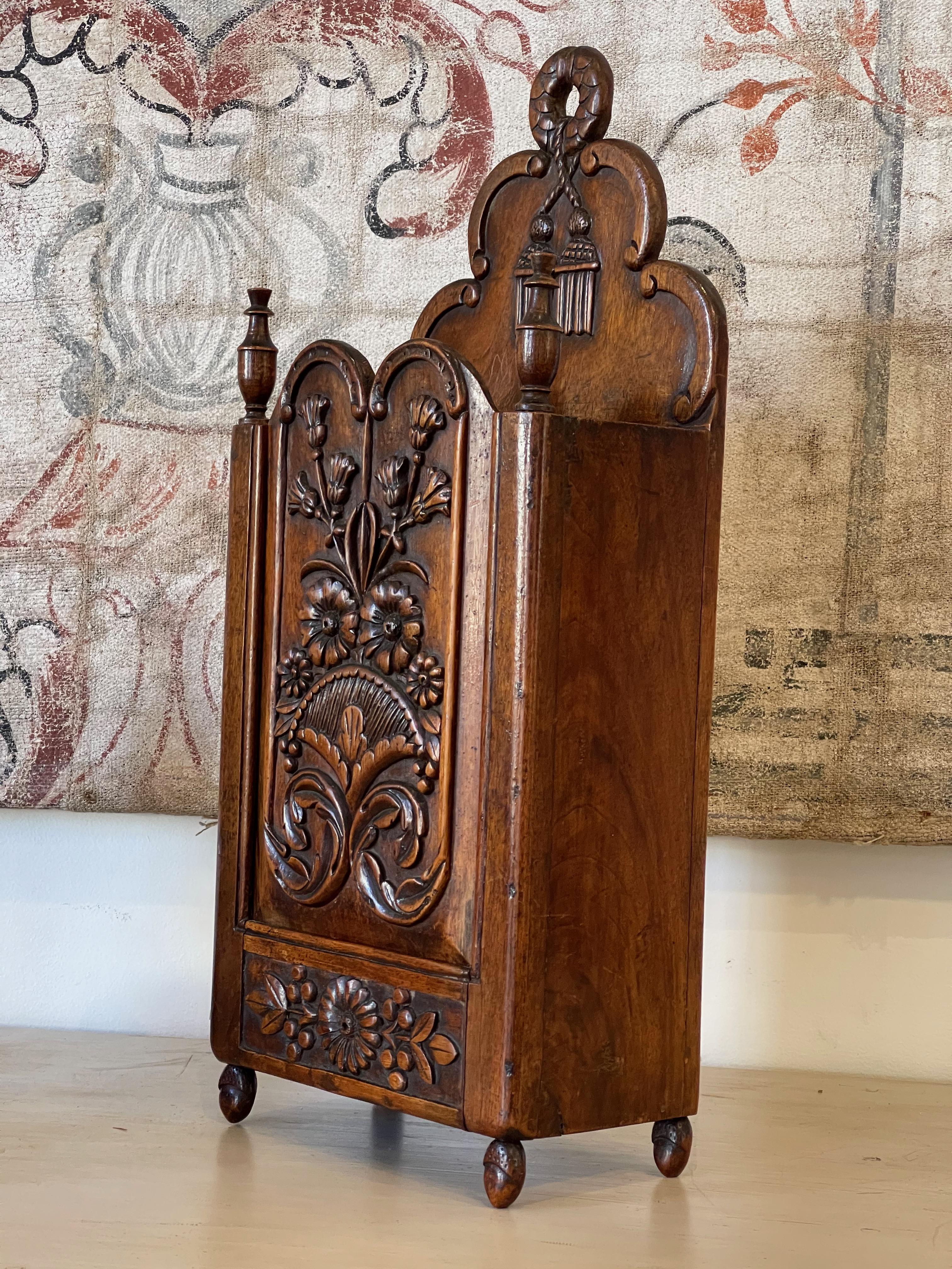 19th century French Provincial Fariniere, walnut with nicely detailed hand carved relief on front panel. A fariniere is a sliding paneled box used for storing flour and, more specifically, for flouring fish.