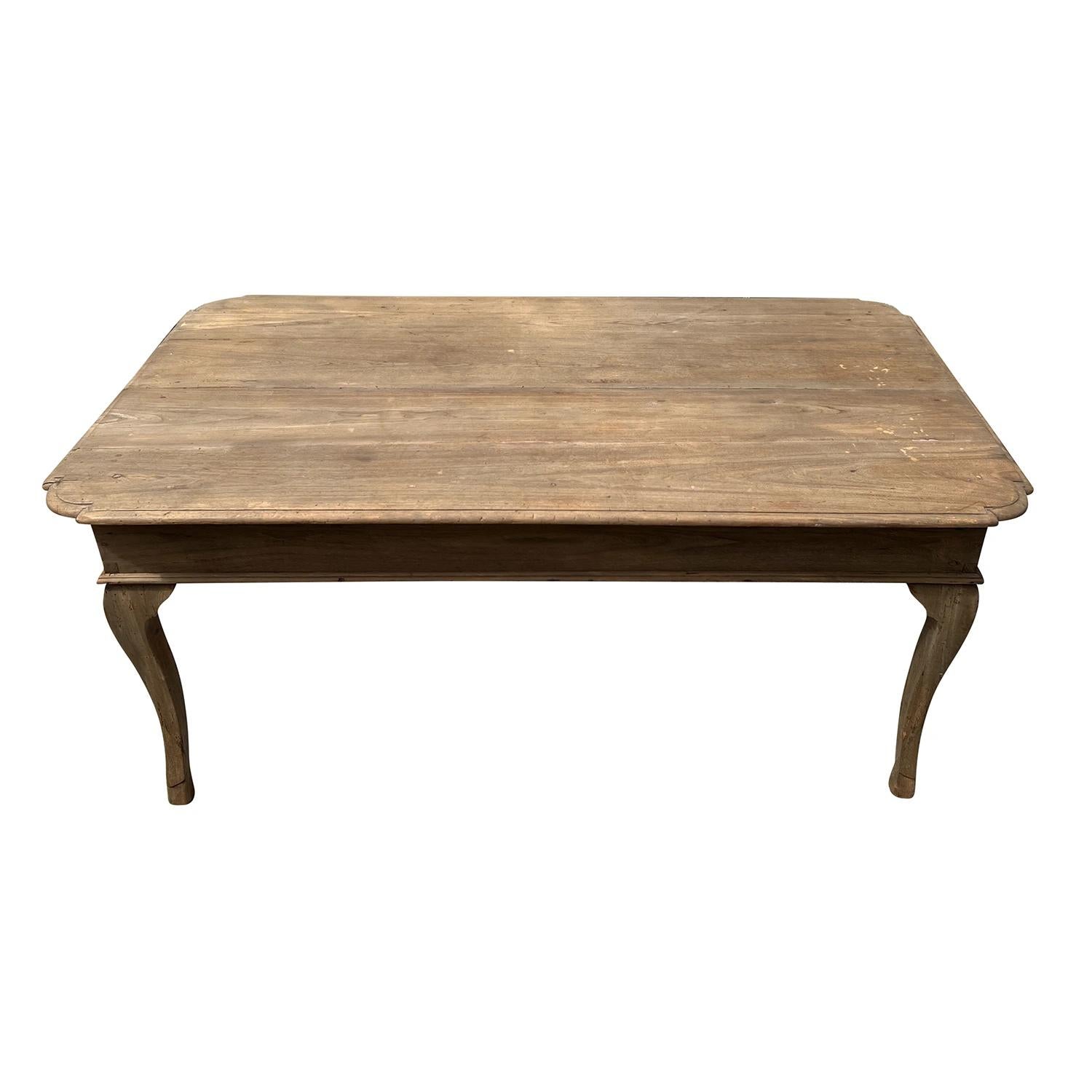 An antique and massive French Provincial dining room table or work table made of hand crafted Fruitwood, in good condition. The detailed top of the early 19th Century farm table is made of planks. Beautiful aged and distressed patina on the wood