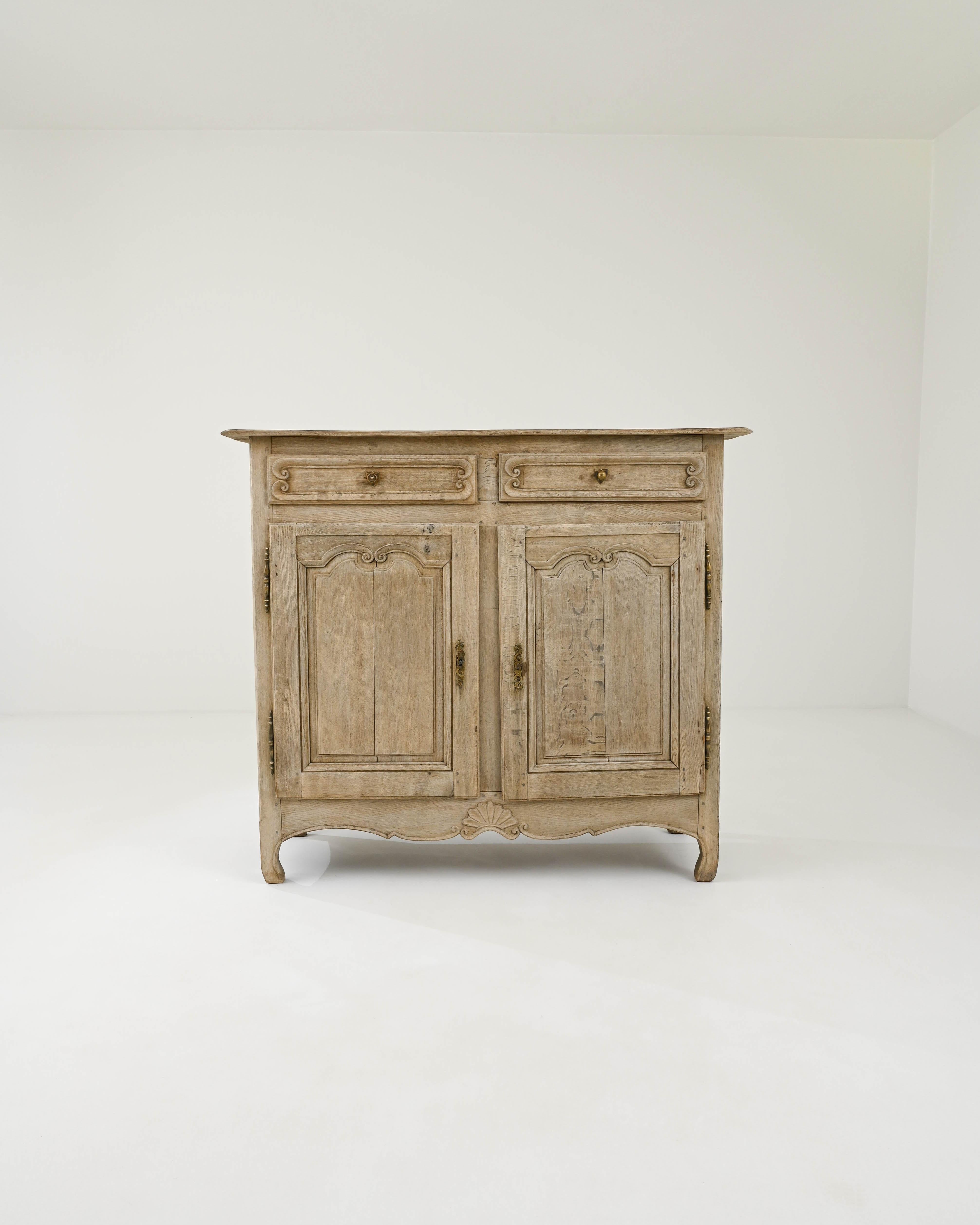 The attractive design of this Provincial oak buffet gives it a light and graceful personality despite its generous proportions. Hand-built in France in the 1800s, the upper drawers sit at shoulder height; below, cupboard doors open to reveal a