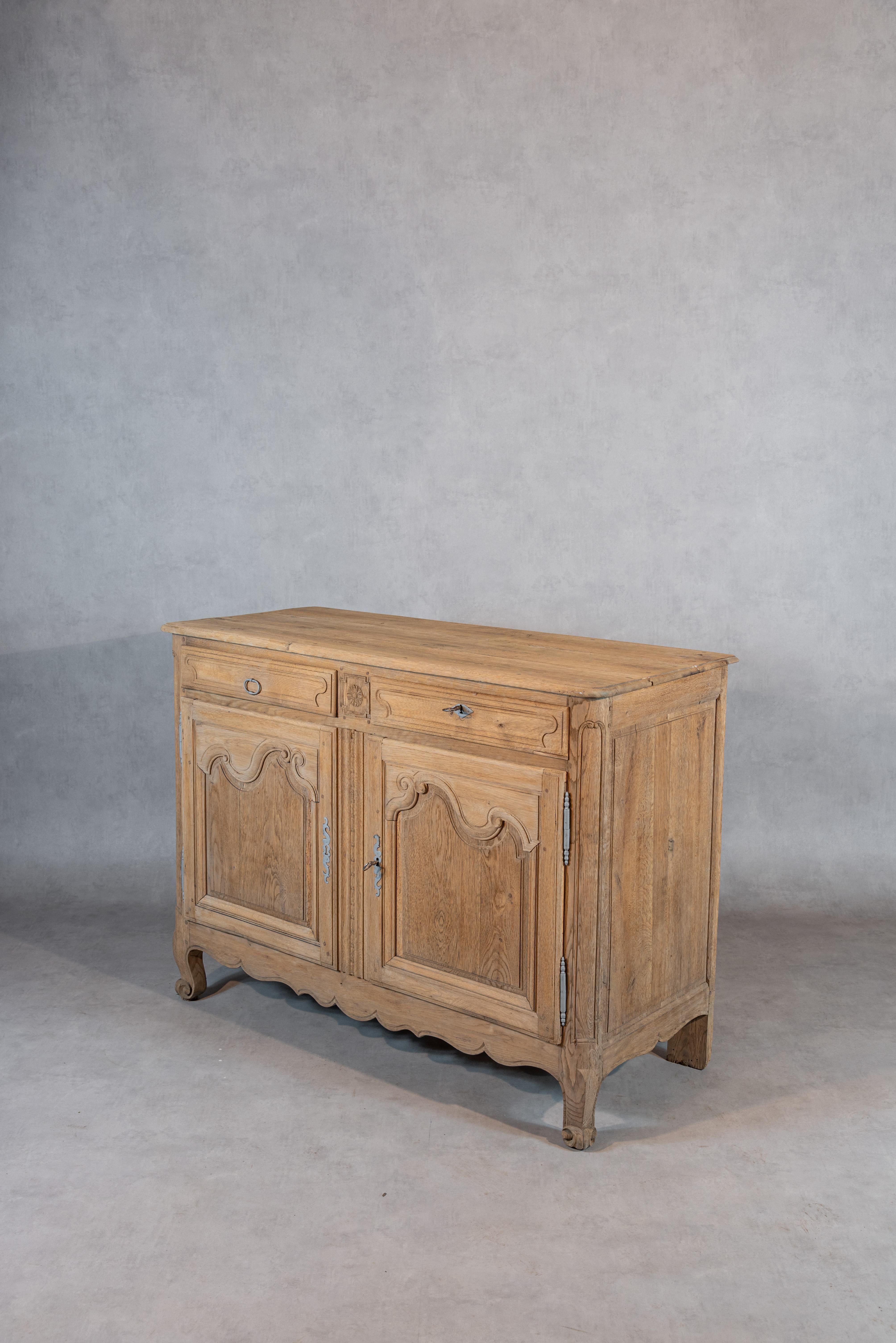 Elevate your living space with the exquisite 19th-century French provincial oak buffet, a testament to the enduring allure of French provincial design. Meticulously crafted from solid oak, this buffet has undergone a transformative sandblasting