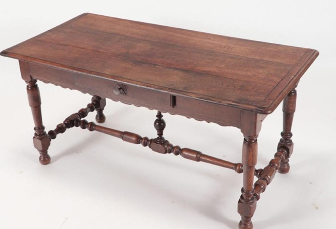 19th century French Provincial Oak Farm Table with Drawer and Stretcher Base. Turned legs and center spindle accent. France, 1801-1900. Measures: 28.25