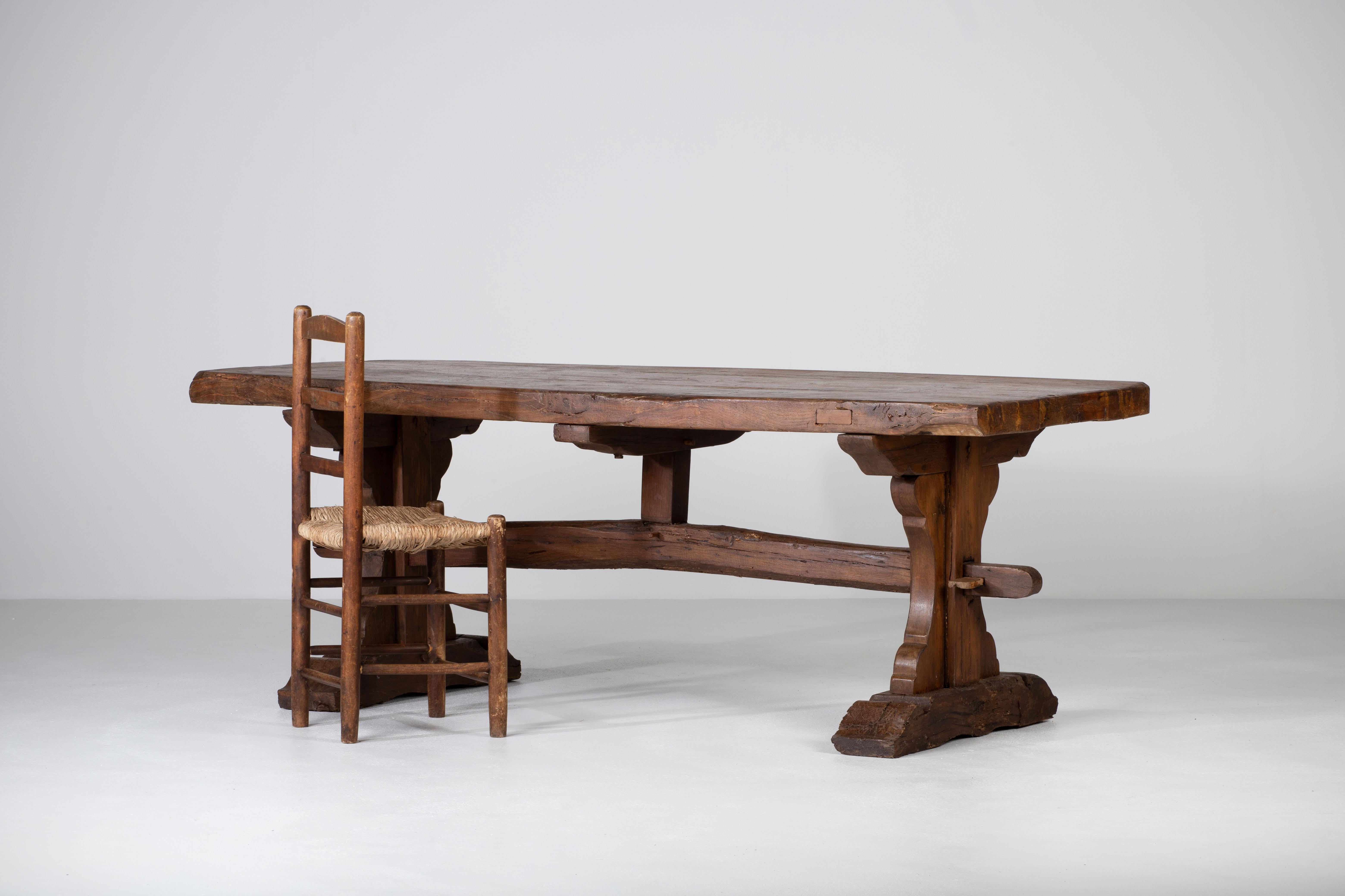 Authentic 19th farmhouse trestle dining table constructed from solid oak. 
It features a very nice patina, the large top is crafted from 2.5 inch thick oak timbers supported by a trestle style base. 
Good great old patina and a warm and worn