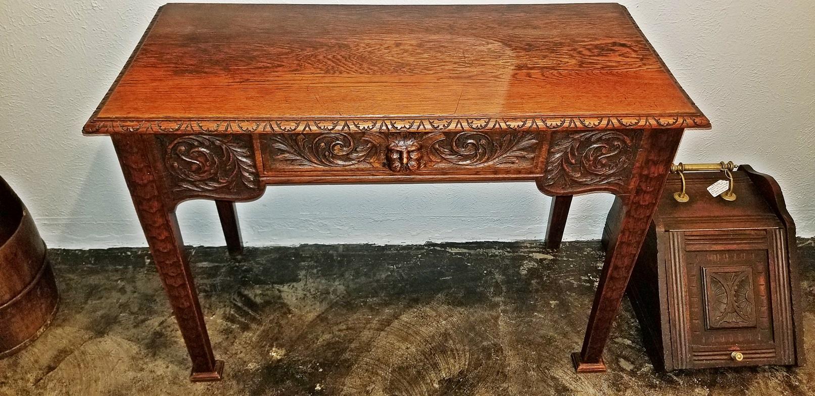 Lovely French Provincial oak side or console table from circa 1880.
Heavily carved with ‘Green Man’ Head on front drawer as central motif.
Probably made in Northern France, in the Ardennes Region, it has a strong Germanic or Flemish