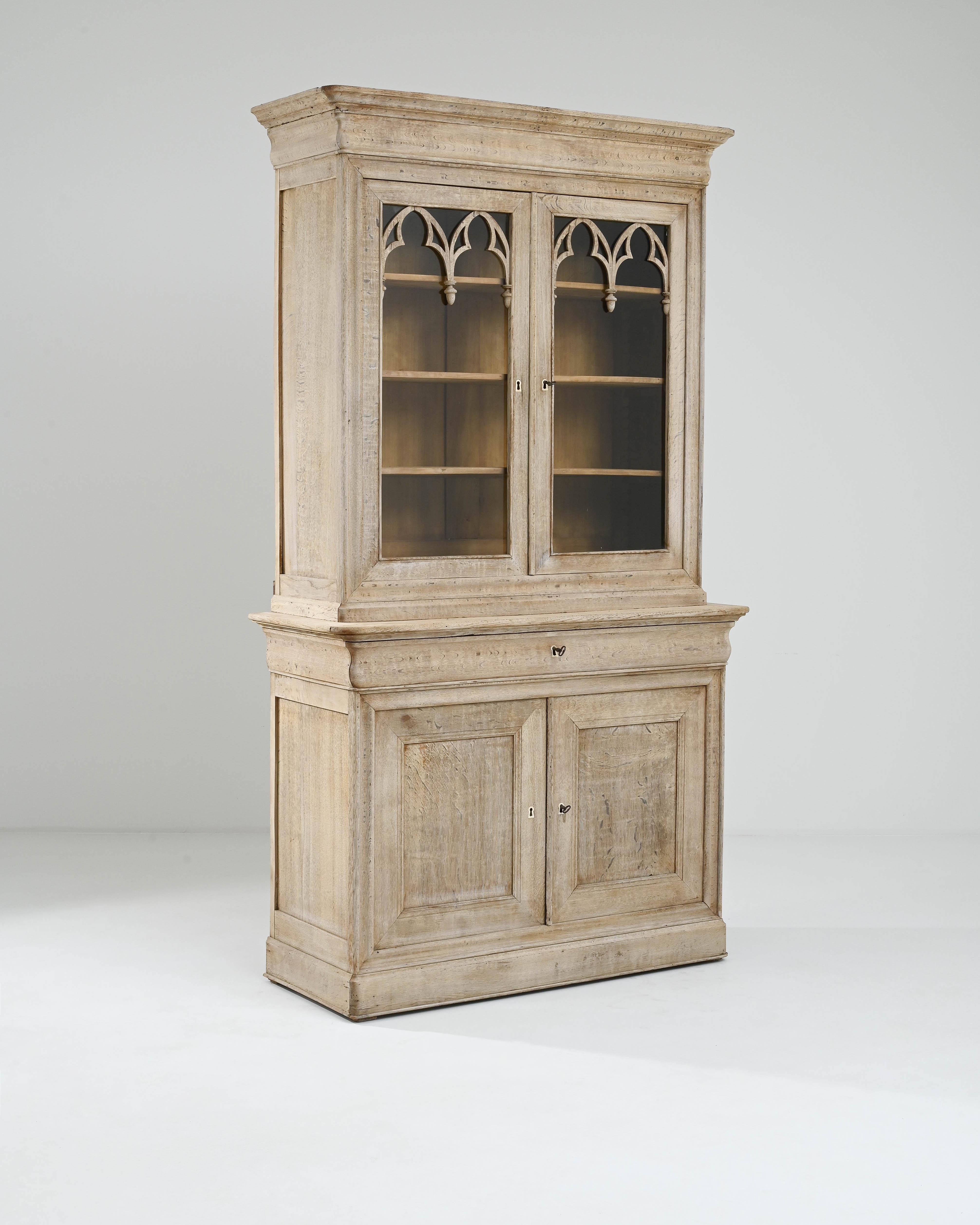 This delightful vitrine in natural oak would have originally been used to display the prized glass and chinaware of a Provincial household. Made in France in the 1800s, the elaborate wooden tracery which decorates the window panes evokes the