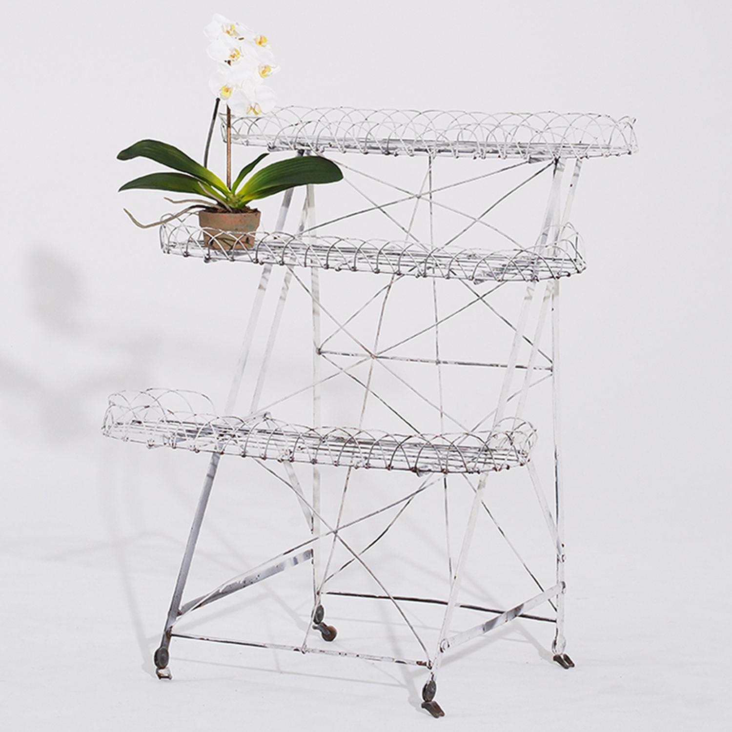 An antique French three tier staggered garden plant etagere has three oblong levels with each being 7.25