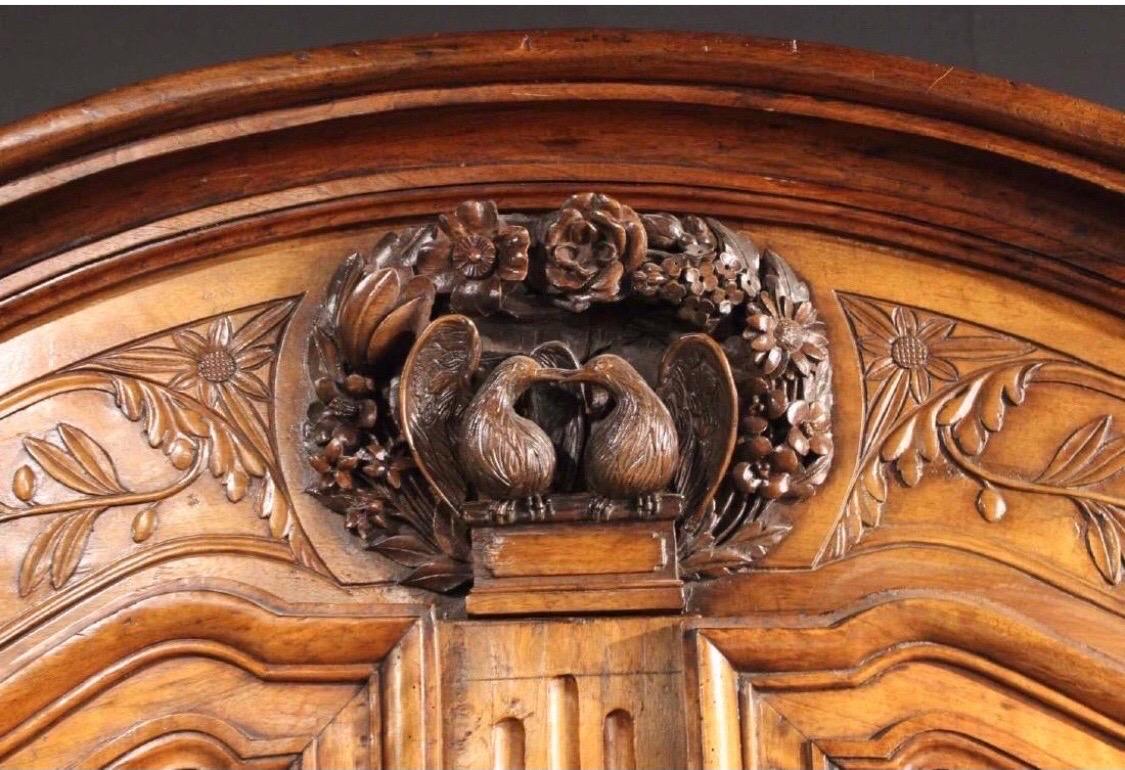 19th Century French Provincial Walnut and Cherryood Armoire with Carved Doves In Good Condition In Charleston, SC