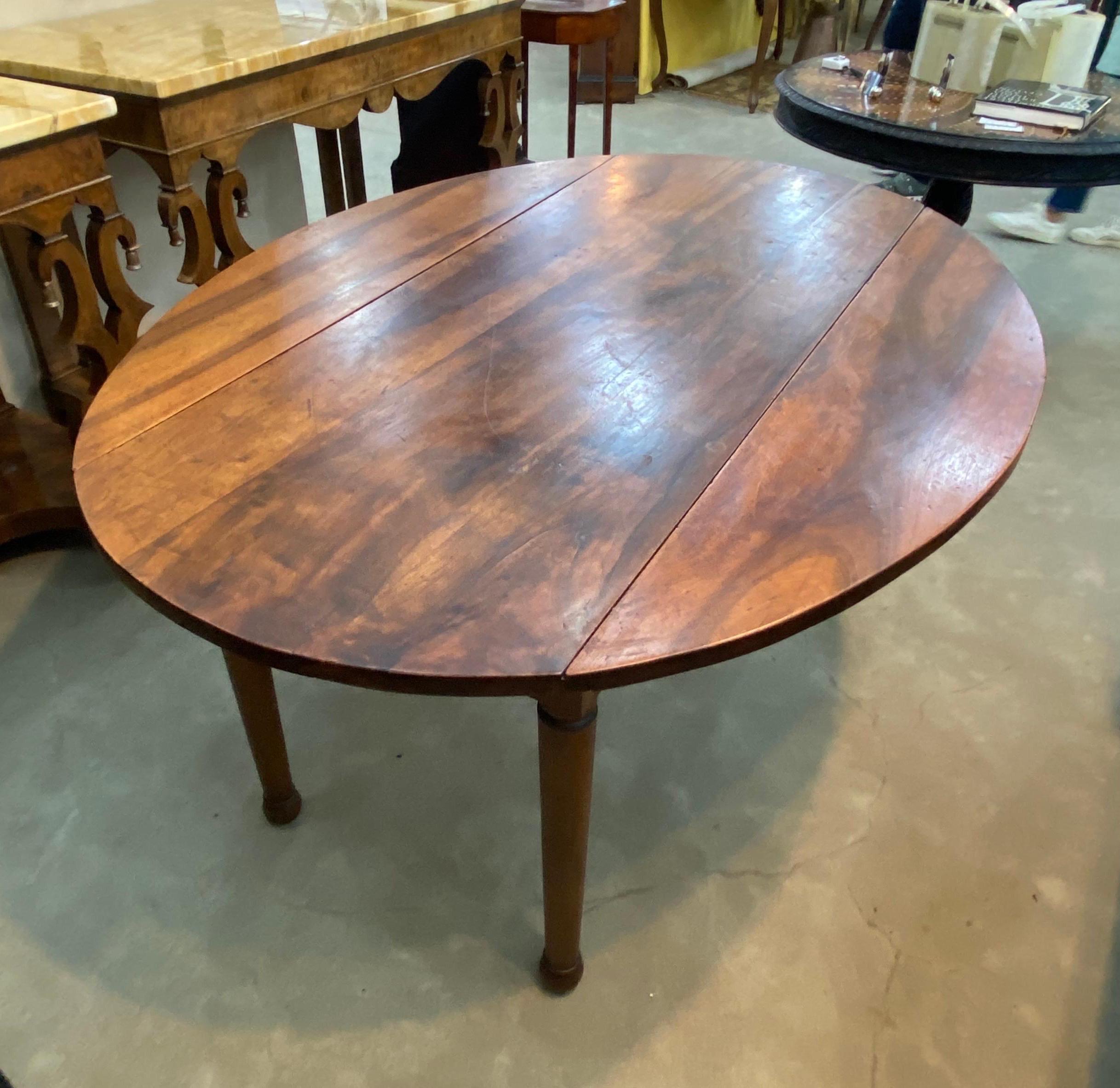 19th century French provincial walnut dining table. Great color and patina. Turned legs, drop leaf form.