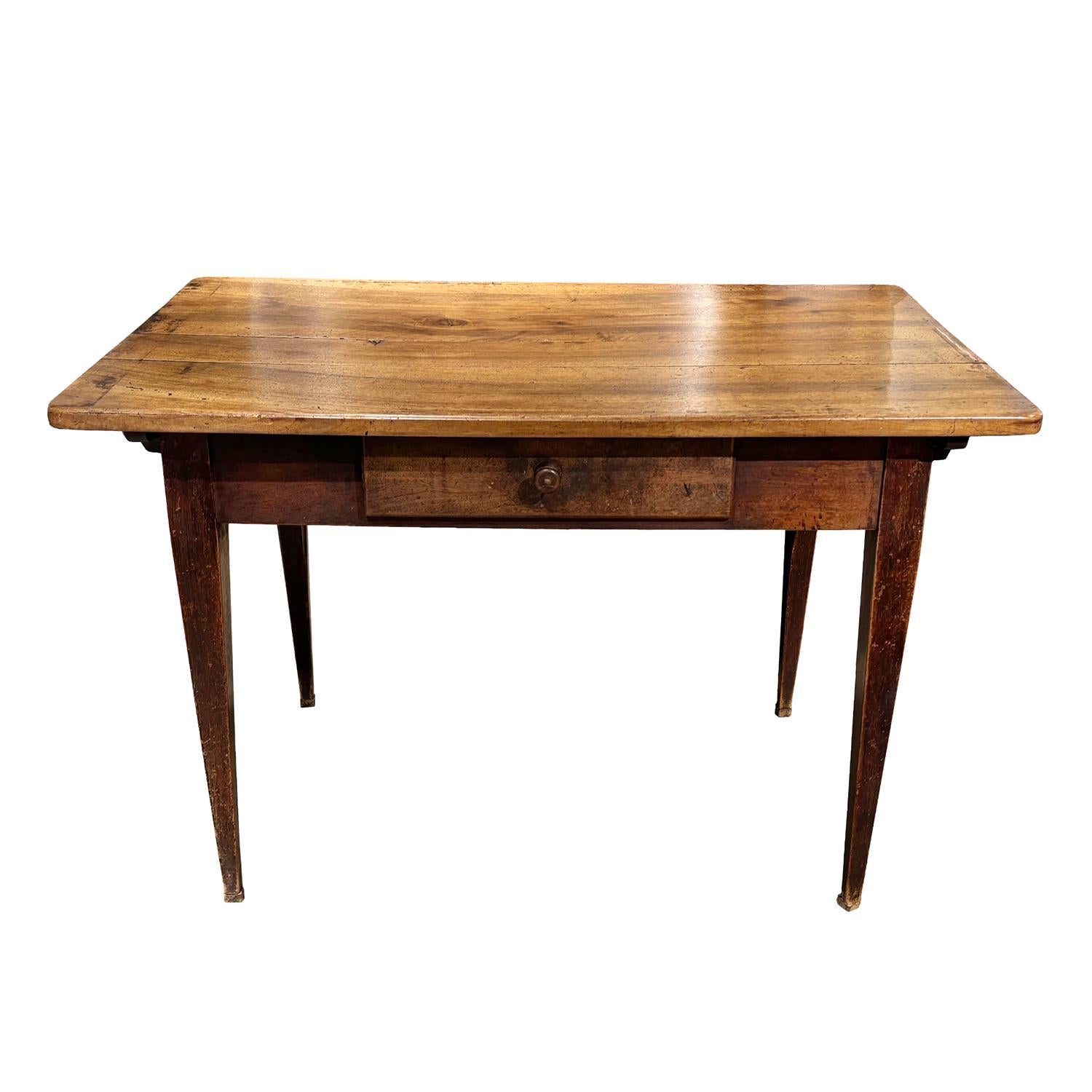 An early 19th Century, antique French Provincial end table made of hand crafted solid Walnut with an aged, warm patina, in good condition. This rustic farm house side table features a classic rectangular top above a wide apron that runs along all
