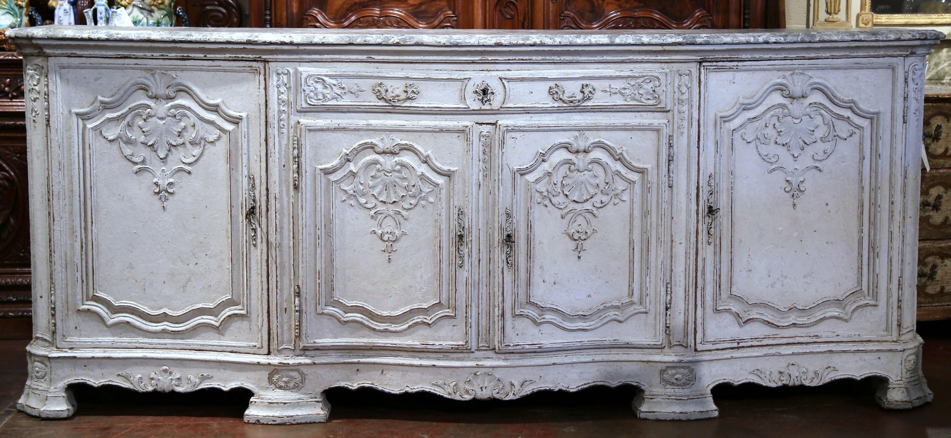 Place this elegant antique gray painted enfilade in your dining room as a serving and storage piece. Crafted in Paris, France circa 1860, the Classic, French serpentine buffet sits on eight sturdy feet and features detailed shell motif carvings on