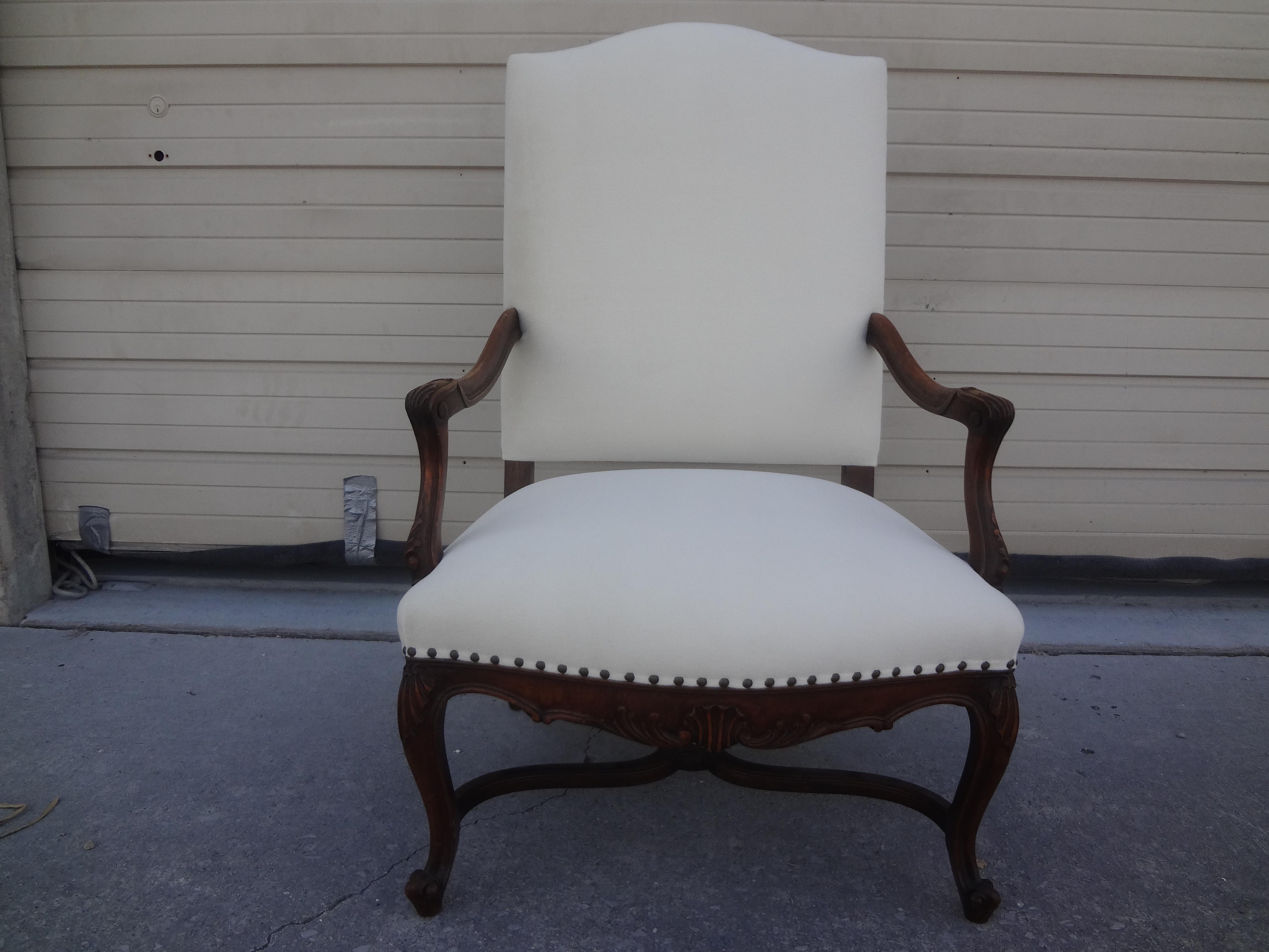 19th century French Regence style walnut chair. This stunning 19th century French Régence style walnut fauteuil, armchair or side chair has a lovely Entretoise or cross stretcher between the four legs. This antique French chair has been