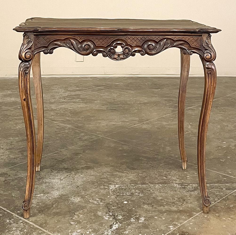 19th Century French Regence walnut end table ~ side table is a perfect example of the style transition that occurred between the Louis XIV and the Louis XV styles. Bold, naturalistic carved detail abounds on all four sides of the apron, including a