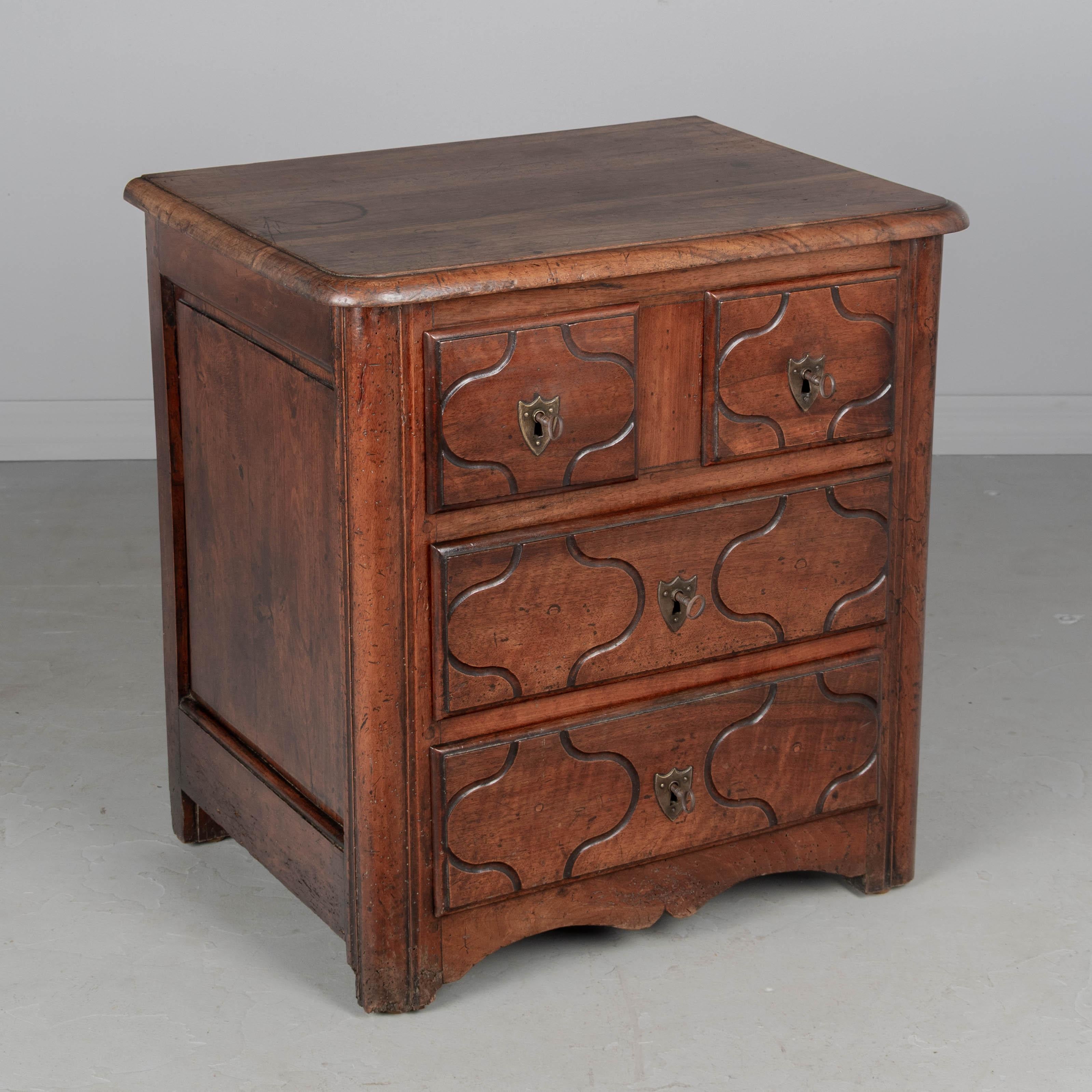 Una commode Parisienne in stile Regence francese del XIX secolo realizzata in noce massiccio. Quattro cassetti a coda di rondine con semplici dettagli intagliati e ferramenta in bronzo. Serrature funzionanti con quattro chiavi. Buona fattura con