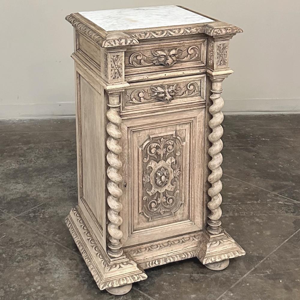 19th Century French Renaissance Barley Twist Nightstand with Carrara Marble is a marvel of the cabinetmaker's art!  Crafted from solid, old-growth oak, it features a squared architecture that is enhanced by two protruding columns flanking the front