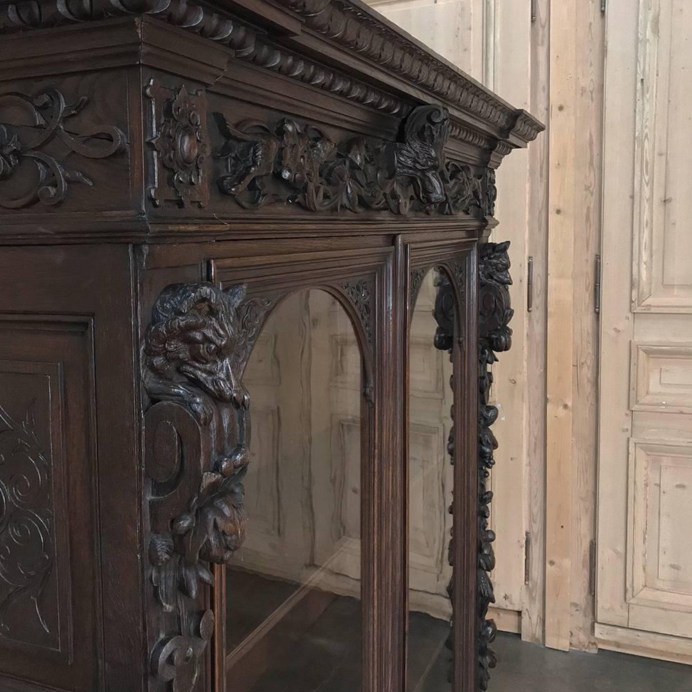 19th century French Renaissance Barrister's Bookcase was sculpted from old-growth oak in elaborate three dimensional splendor with della robia, or bounty of the earth cascading down the cornerposts and across the crown, centered with a fox's head.