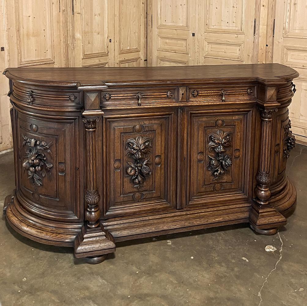 19th century French Renaissance buffet with rounded sides was rendered from solid oak to last for centuries! Although the design includes column pediments which on paper make the 23.5