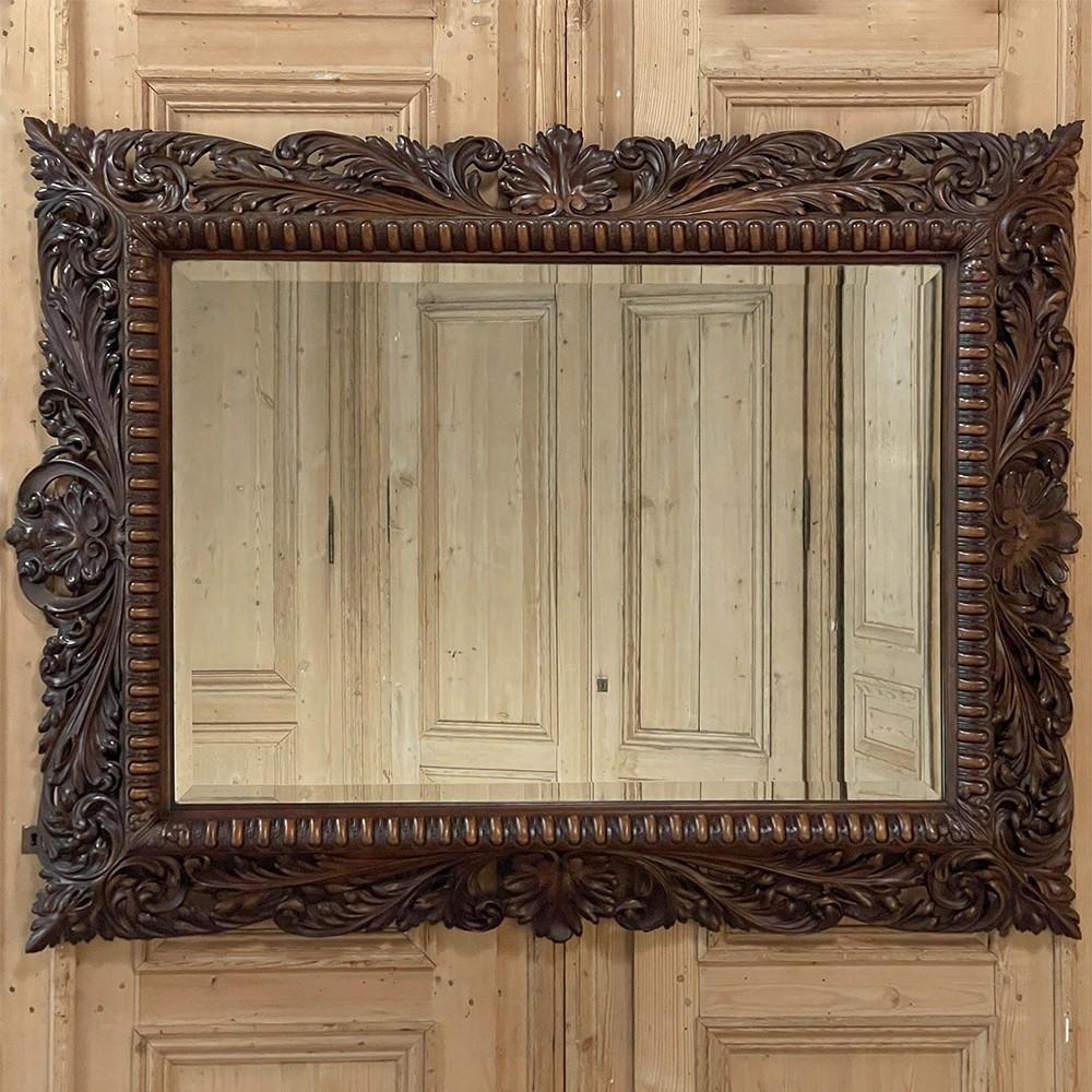 19th Century French Renaissance Carved Walnut Wall Mirror is evidence of a wood sculptor's superior talent!  Rendered from finely grained sumptuous walnut, the frame is carved all around, with shell within a scrolled crest centered at the top, and a
