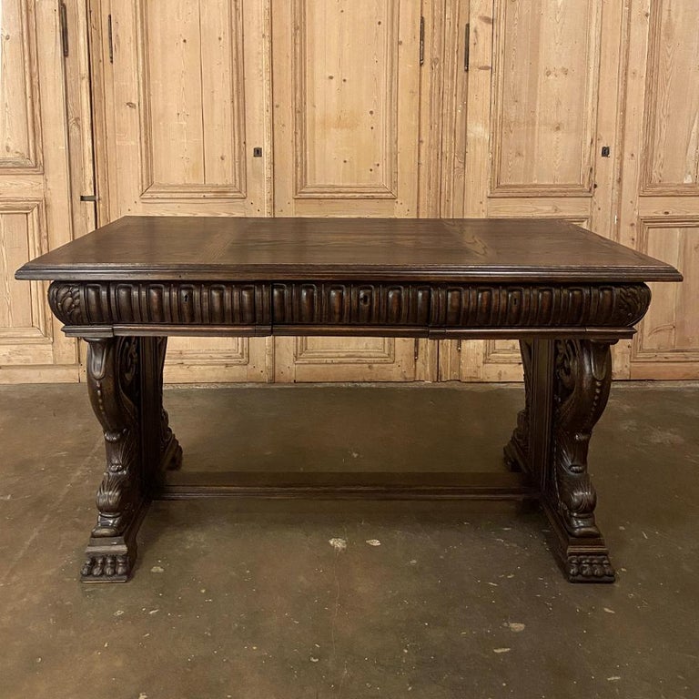 19th Century French Renaissance desk with dolphins is a remarkably sculpted work with fully carved apron all around, making it a great choice for placement in the center of the room if so desired. Hand-crafted from old-growth oak, it features a trio