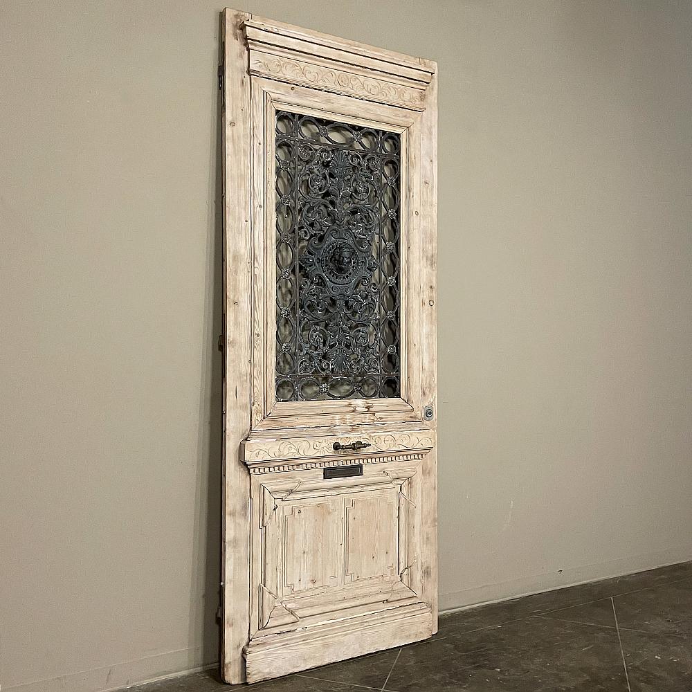 19th Century French Renaissance exterior door with cast iron is a stunning example of Beaux Artes Period craftsmanship and timeless architecture from a bygone era! Meticulously hand-crafted from old-growth yellow pine, it features a majestic