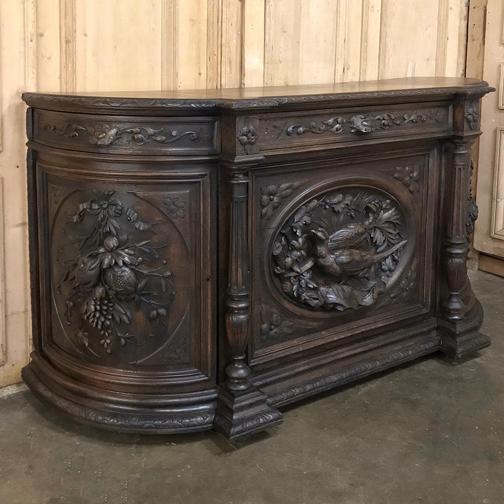 19th century French Renaissance hunt buffet glorifies the bounty of nature with a pair of pheasants taking center stage in exquisite full relief sculpture. Grapes, fruit and floral motifs in full relief appear on the curved side doors. The three