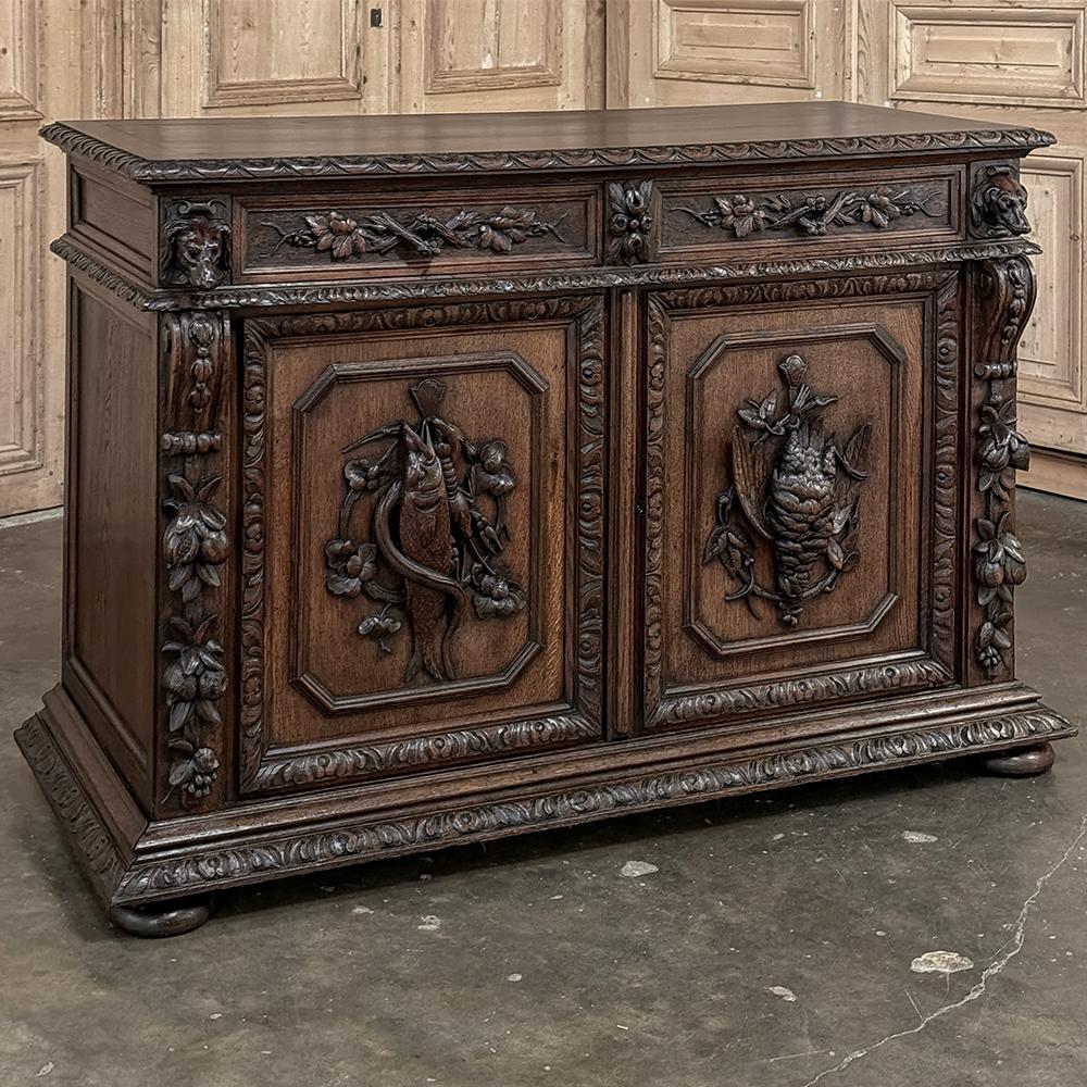 19th Century French Renaissance Hunt Buffet is a classic representation of the genre, with captivating and realistic hand-carved details and sculpture across the entire facade.  Rendered from sold old-growth hand-select oak, it features a solid