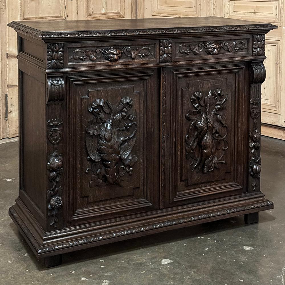 19th Century French Renaissance Hunt Buffet is a classic representation of the genre, with captivating and realistic hand-carved details and sculpture across the entire facade.  Rendered from sold old-growth hand-select oak, it features a solid