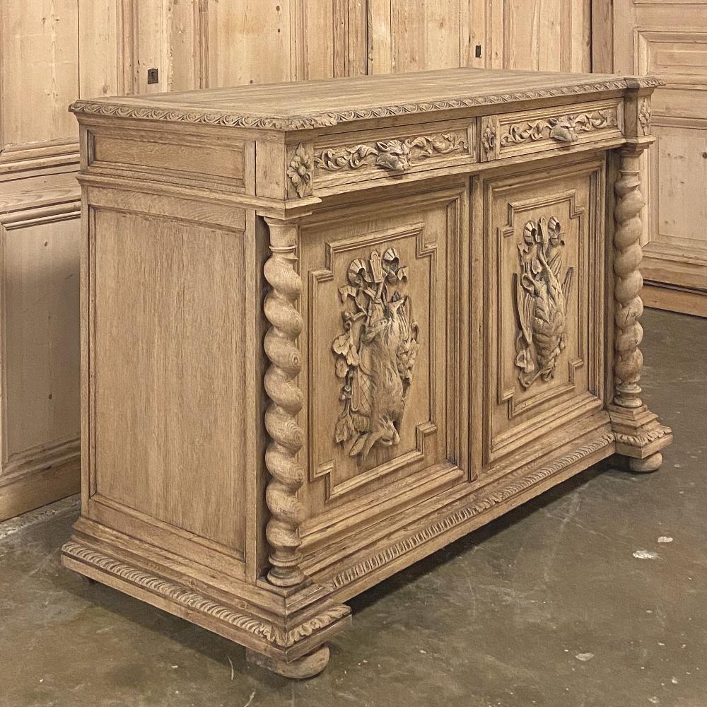 19th century French Renaissance hunt buffet in stripped oak is a more uncommon example of the genre, which usually is expressed with three or four doors, two tiers, and much larger sizes. This example is more of a typical two door buffet size,
