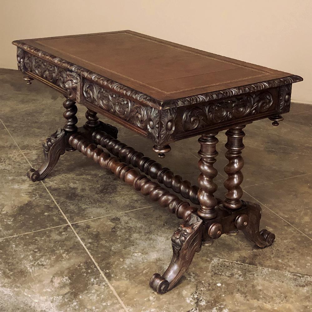19th Century French Renaissance leather top writing table is perfect for adding an Old World touch to any room! Boldly carved edging around the tooled leather top is just the beginning, with fully carved apron wrapping around the entire perimeter