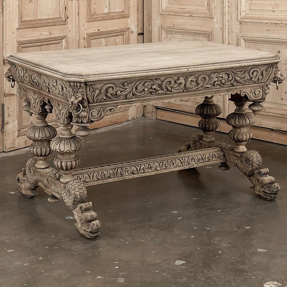 19th century French Renaissance library table in stripped oak is perfect as a center table creating a timeless old world effect. The rectangular top features a double-molded edge and mitered corners. Under each corner appears a lion's head in full