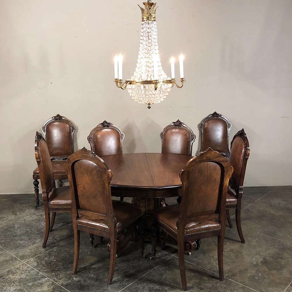 19th century French Renaissance ~ Louis XIV walnut pedestal table is a study in naturalistic beauty, with four elaborately carved and scrolled legs mated with a massive pedestal which supports the top with the help of four corbels adorned with