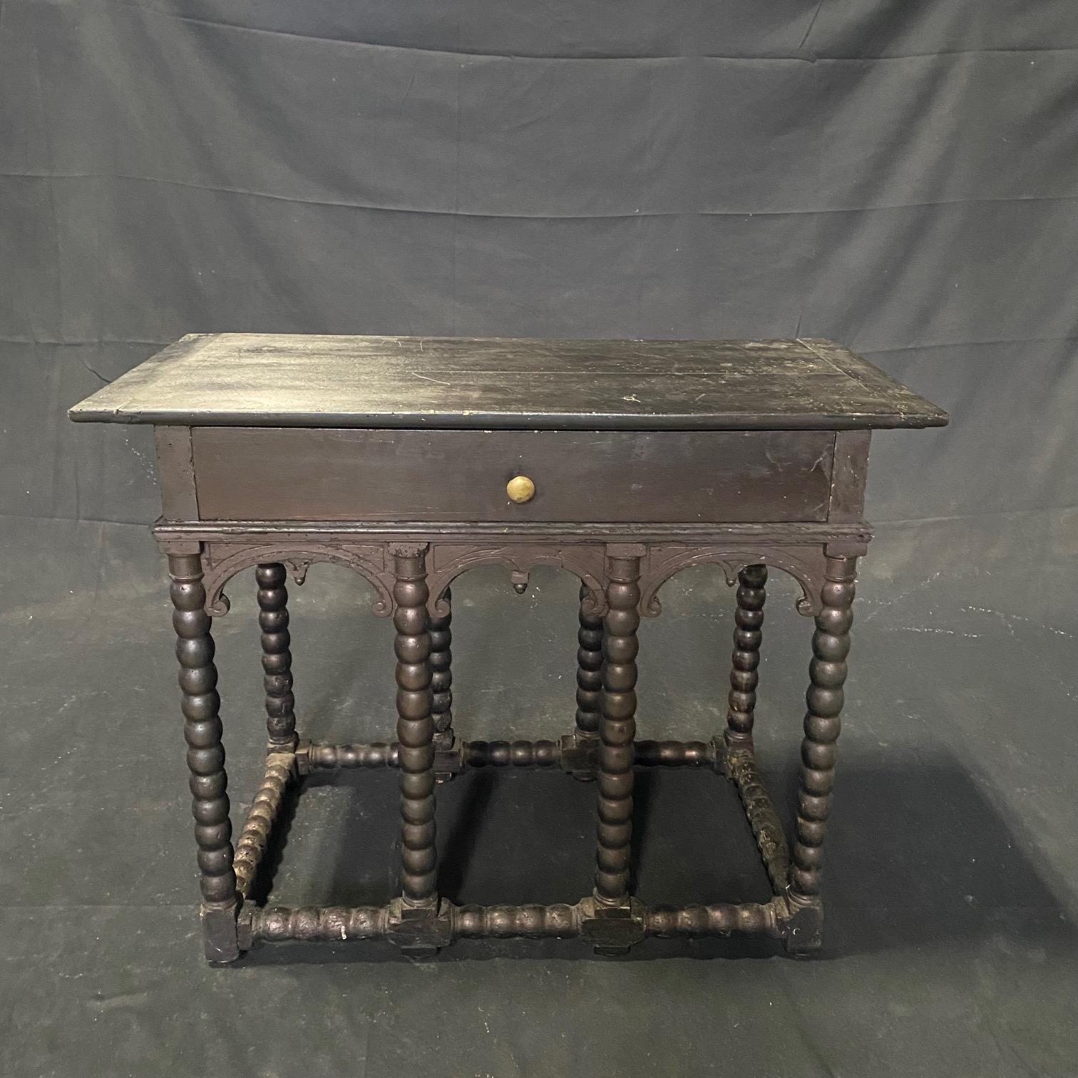 19th century ebony console table or entry hall table was made in the Renaissance style and also emulates Napoleon III, with the early eight barley twist legs, all connected with a barley twist stretcher. What makes this antique console or hall