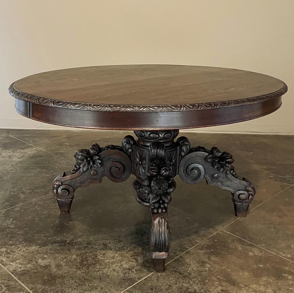 19th century French Renaissance oval center table was sculpted from solid oak to last for centuries! The table top is adorned solely with the sheer natural beauty of the wood enhanced by a demilune gadrooning with fletching motif. The apron is