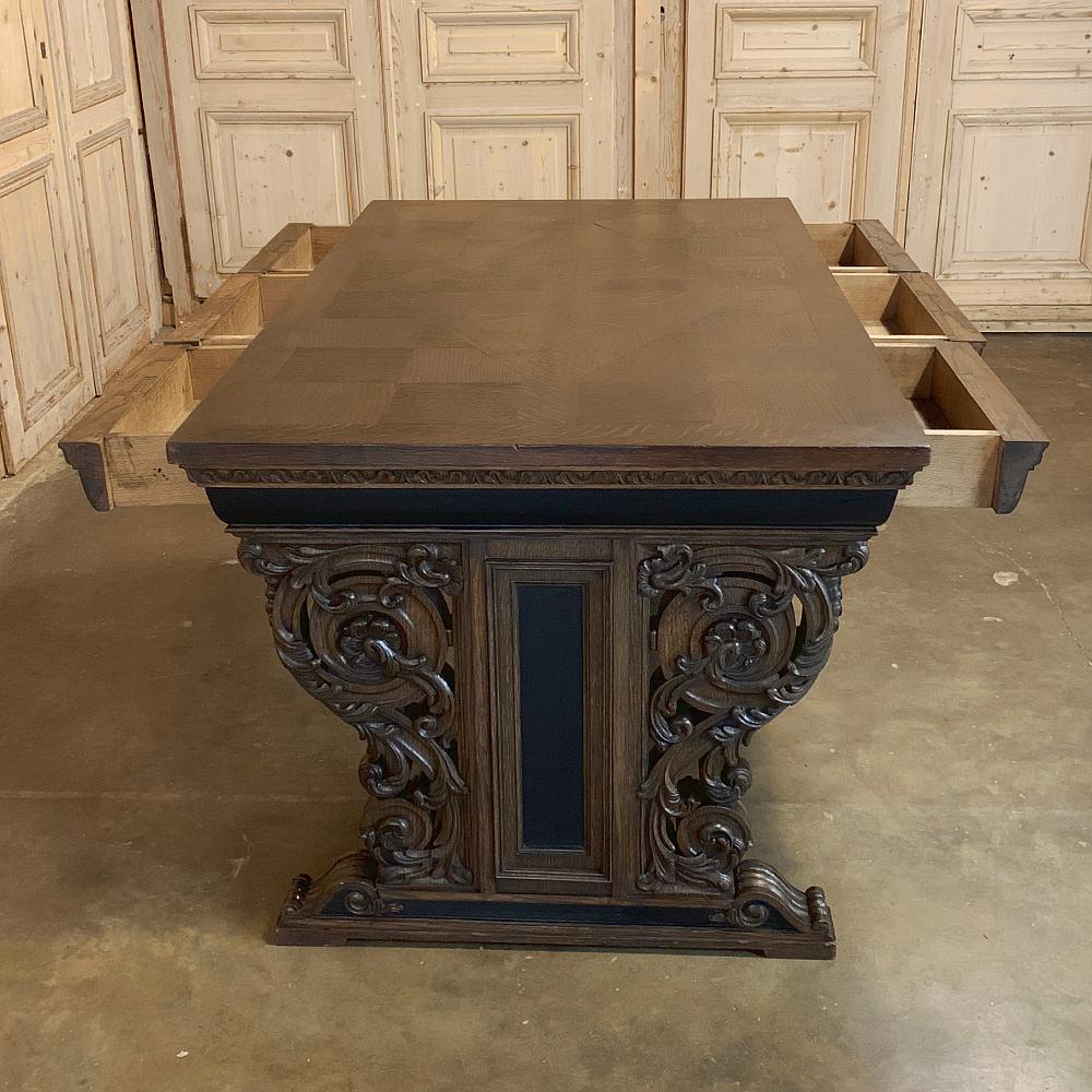 19th century French Renaissance Partner's Writing desk features timeless architecture combined with exceptional hand carved detail. With drawers on both sides, it can be used by one or two simultaneously. handcrafted from old growth oak, it was