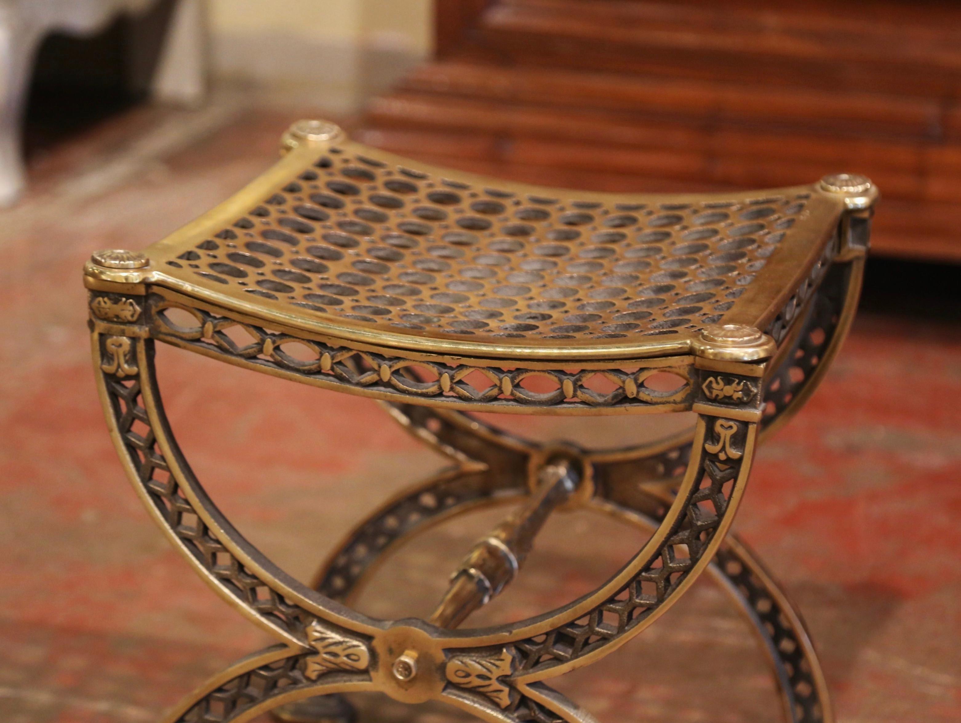 Place this elegant antique stool in a master bathroom and use it as a vanity seating! Crafted in France circa 1880 and made of bronze, the chair stands on forged Dagobert (or Curule) legs connected with a delicate stretcher over a pierces apron; the