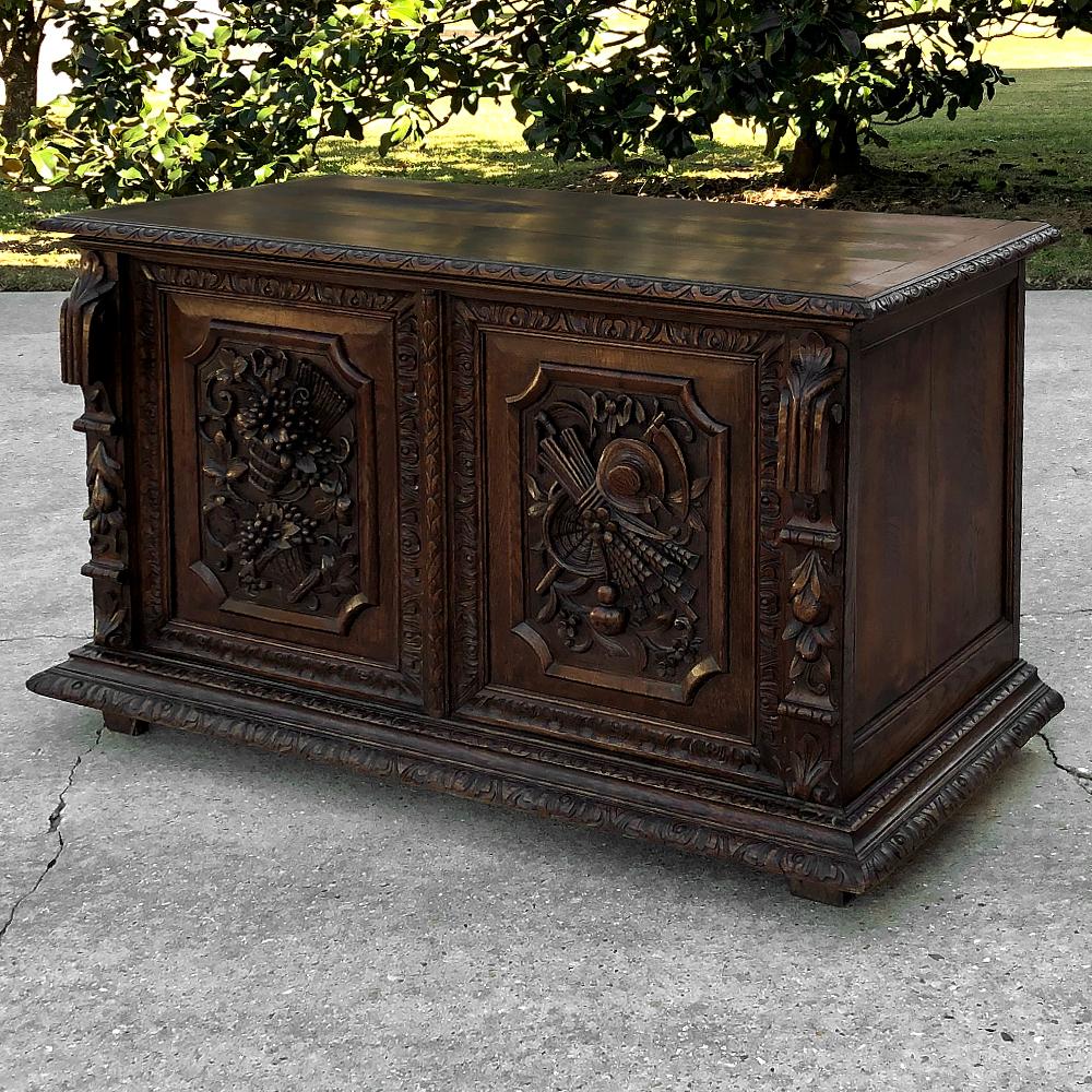 19th century French Renaissance trunk with grape and wheat harvest is a remarkable testament to an obviously talented sculptor who immortalized three concepts with the hand carved magnificence of two works of art! On the left appears a bold relief