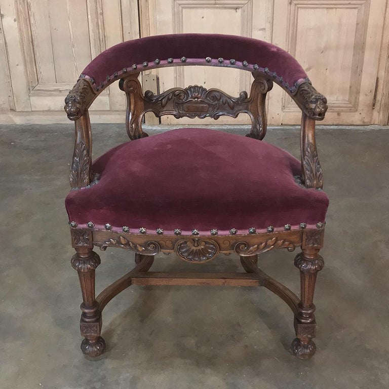 19th century French Renaissance desk armchair was sculpted from select French walnut, and features amazing hand carved detail from the tip of the armrests with sculpted lions' heads to the carved ball feet at the end of the finely turned and carved