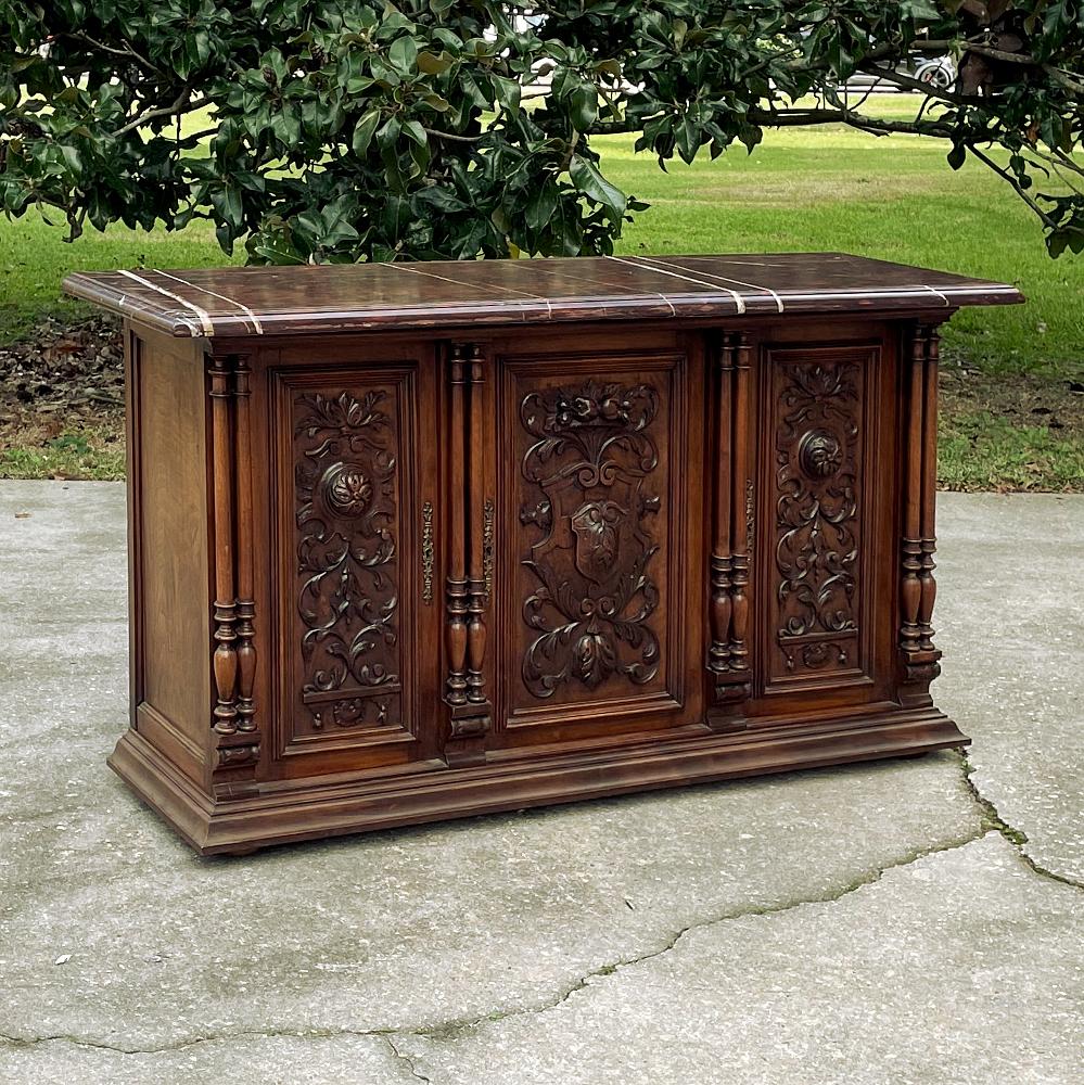 19th Century French Renaissance walnut marble top console or credenza is an exceptional statement piece on a relatively diminutive scale! Topped with lavish rouge marble, it features eight turned columns that provide a framework for the exquisitely