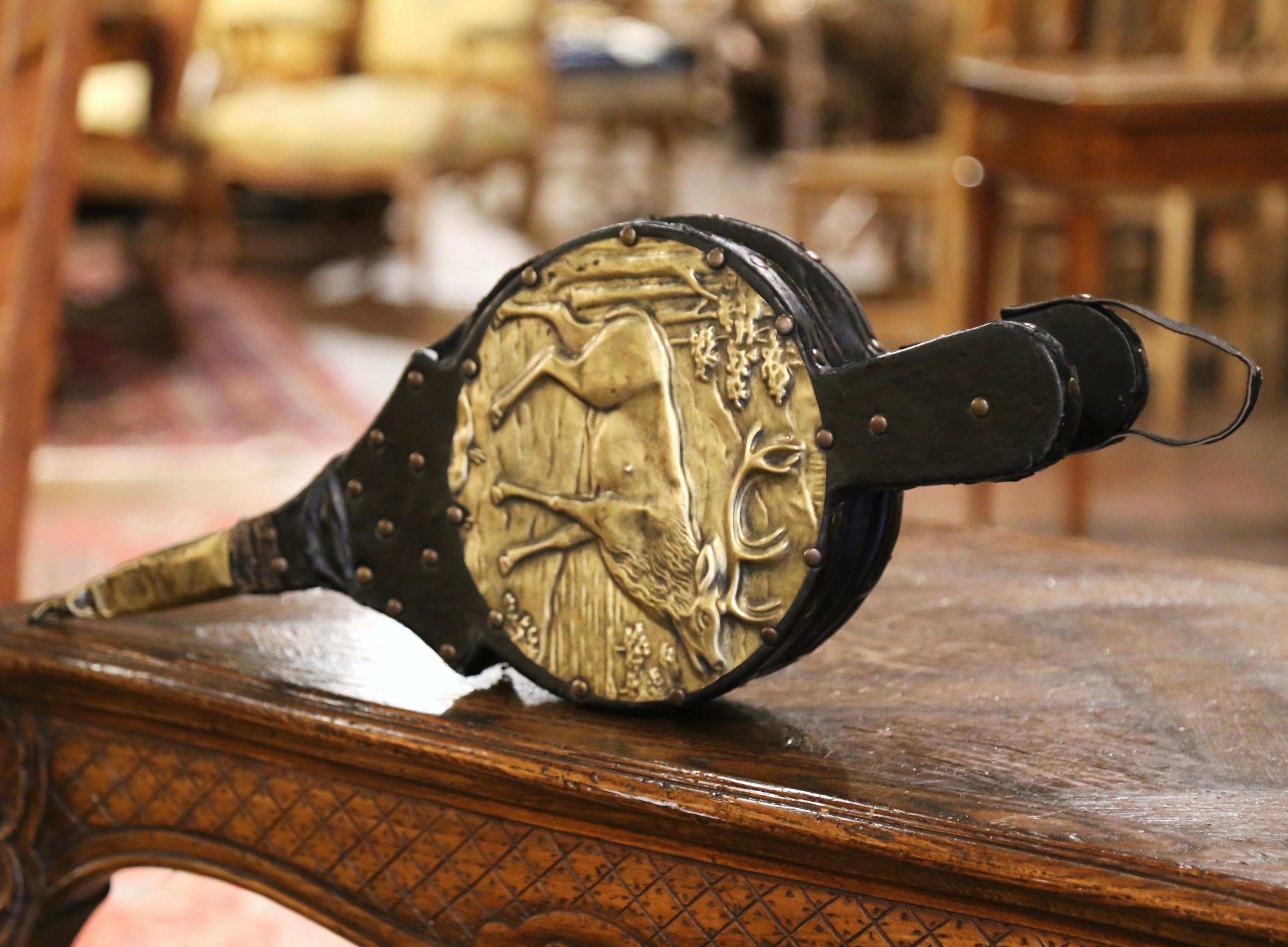 Decorate a fireplace and active the flames with this elegant and useful antique bellows. Crafted in Brittany, France, circa 1880, the fireplace essential features a repousse brass top surface depicting a stag. Double handles at one end, a brass