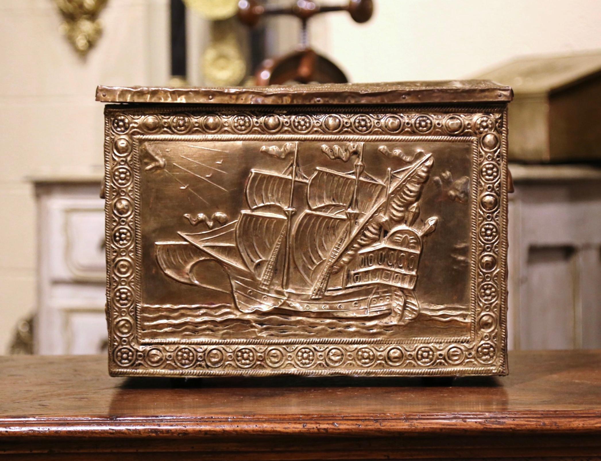 Crafted in France circa 1870 and rectangular in shape, the antique wooden and brass coffer is decorated with repousse sailboat scenes on the top and front while both sides are dressed with handles. The top opens to inside storage. The decorative