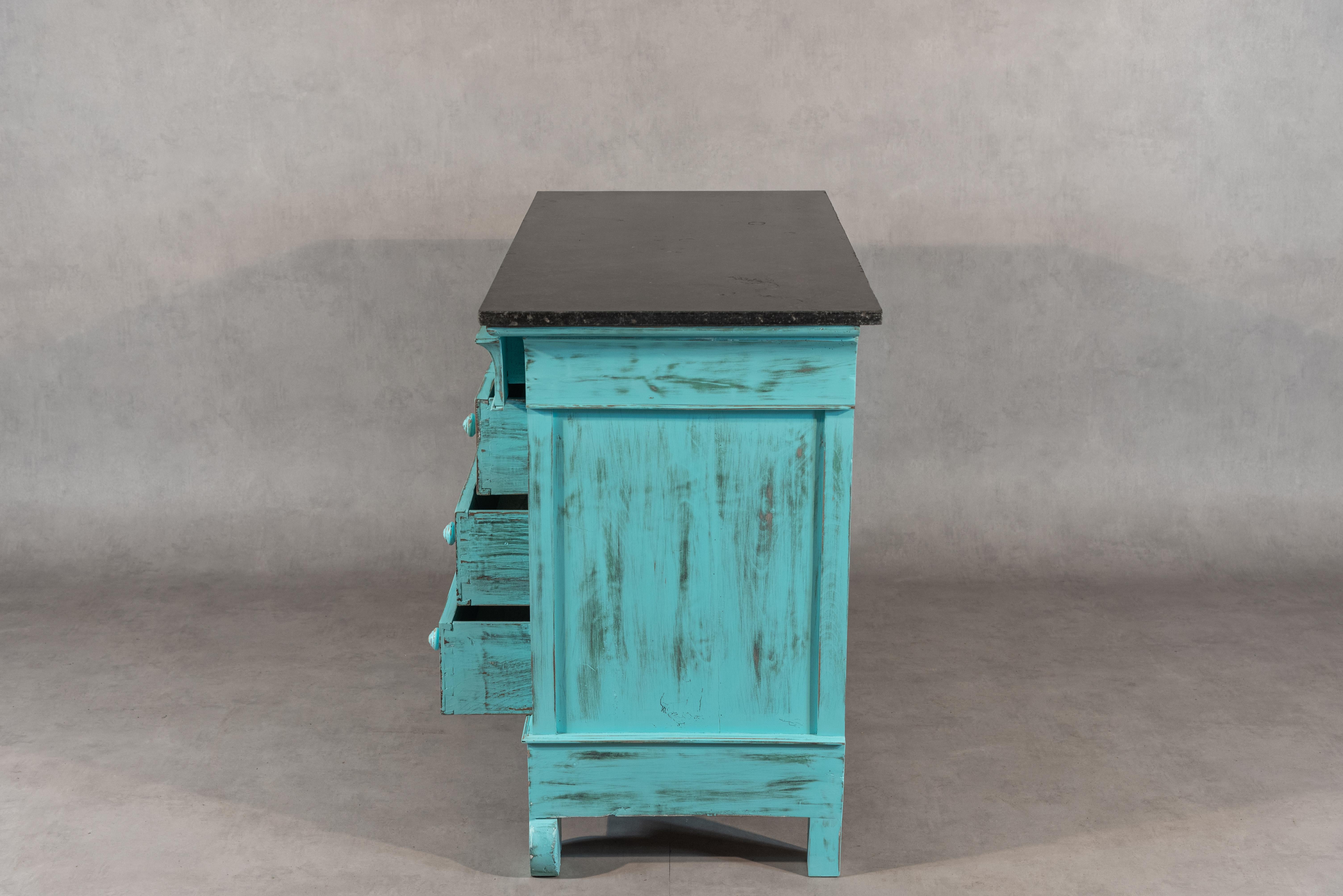 This wonderful French Restauration Period commode has been sanded, bleached, and repainted in a turquoise patina. The wooden knobs on the four drawers add to its charm. Finally, the commode features an impressive Sainte-Anne marble top giving it a