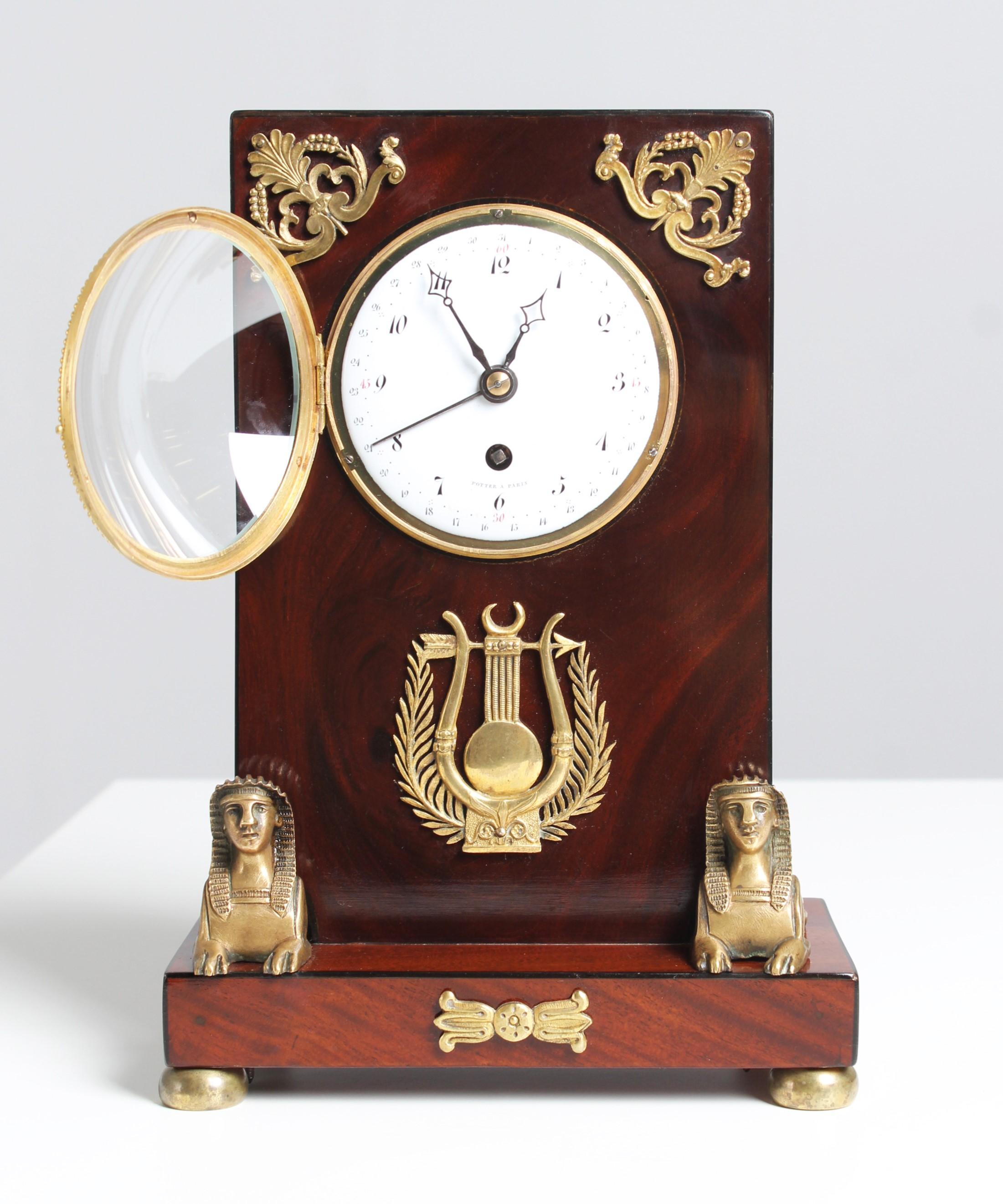 Antique Retour d'Egypte mantel clock

France
Mahogany
first half of 19th century

Dimensions: H x W x D: 29 x 20 x 12 cm

Description:
Extraordinarily small Empire mantel clock in a mahogany case. So-called Pendule d'Audience.

Base plate standing