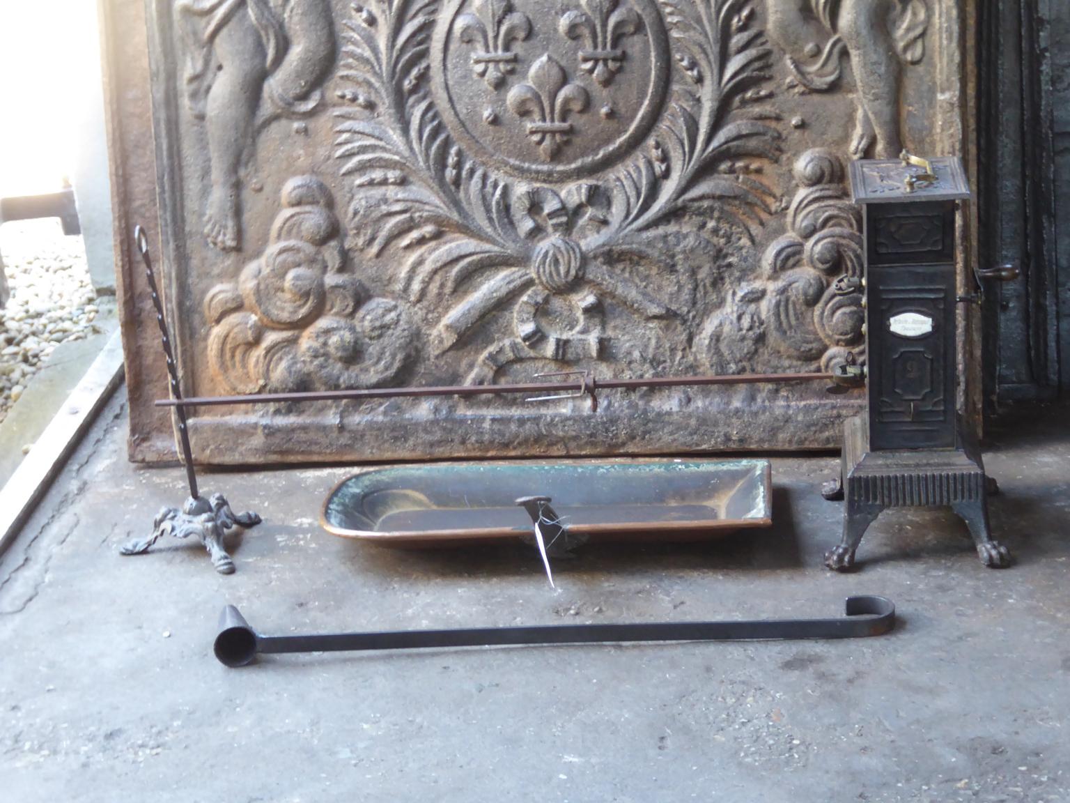 19th century French Napoleon III roasting jack and attachments made of cast iron, wrought iron, copper and brass. The roasting jack can be used for cooking in the fireplace. It is fully functional. It is a complete set.







 