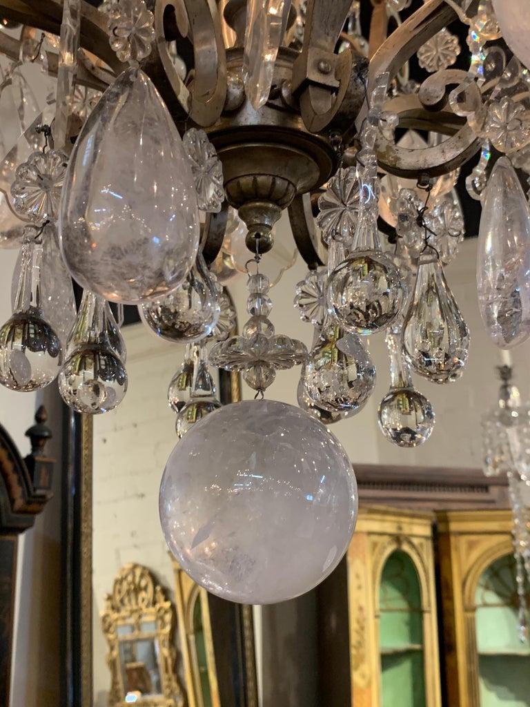 Exceptional 19th century French rock crystal chandelier with 12 lights. Lovely combination of crystals including large rock crystals and smaller teardrop crystals and prisms. The beautifully shaped base is silvered over bronze. Exquisite!