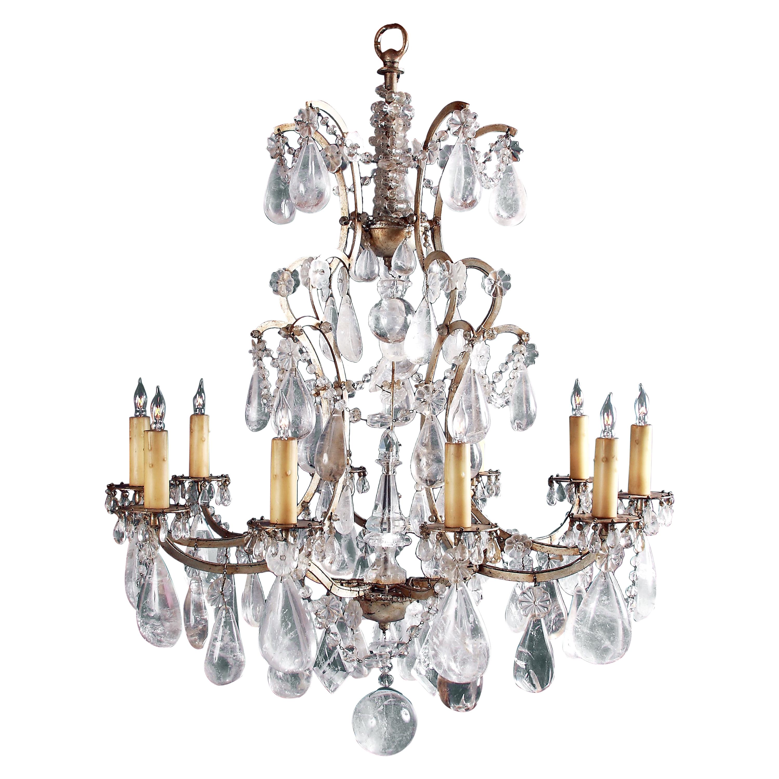 A beautiful and well balanced French mid-19th century rock crystal and white gold over iron chandelier, a rock crystal center spire, drops and ropes. The chandelier is centered by a fabulous rock crystal ball. It holds over 70 handcut superb quality