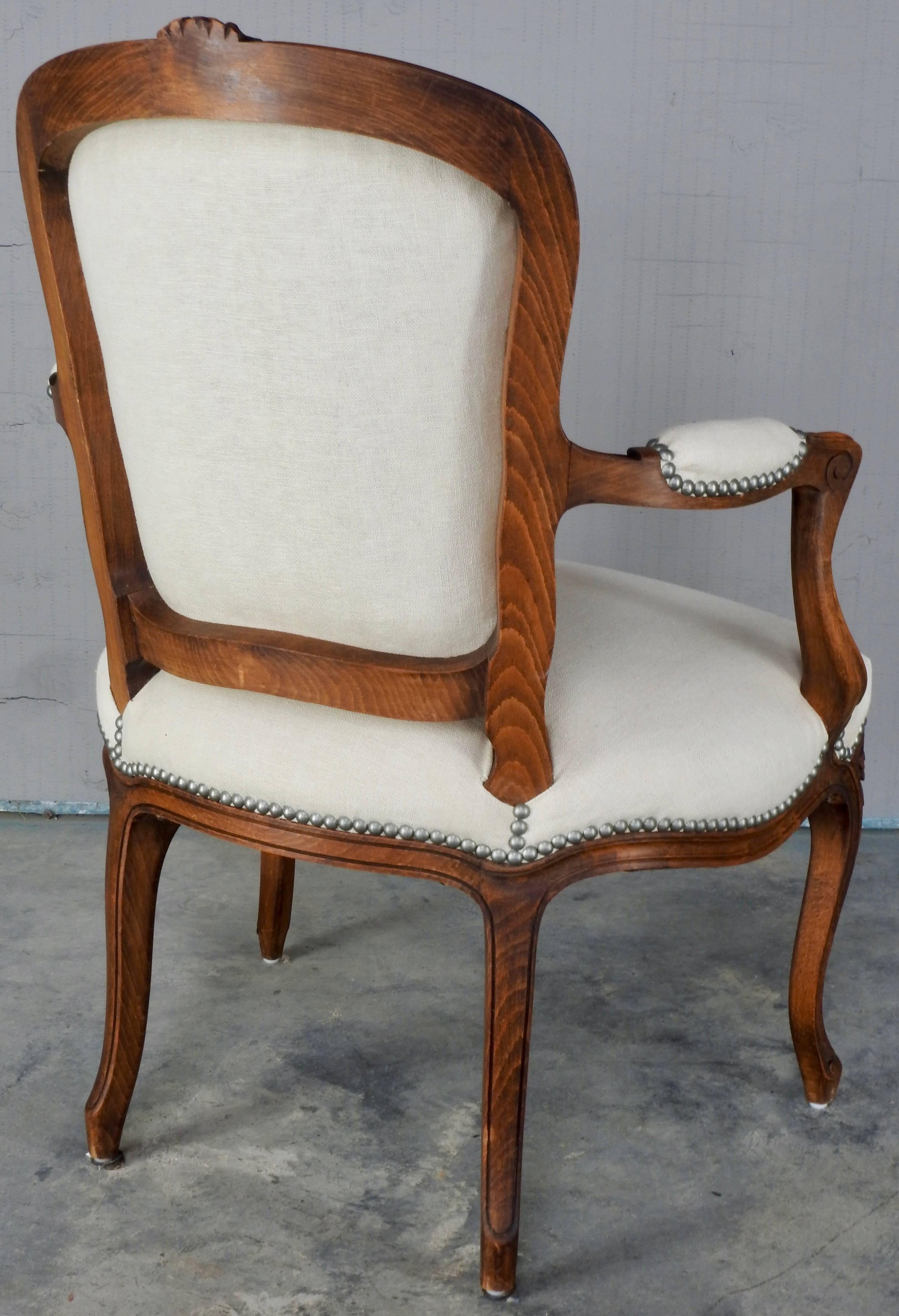 This chair is a beautiful warm walnut in the traditional Rococo style. Covered in a gorgeous Belgian linen this chair will add warmth and texture to any room. Pewter tacks make the linen pop out.