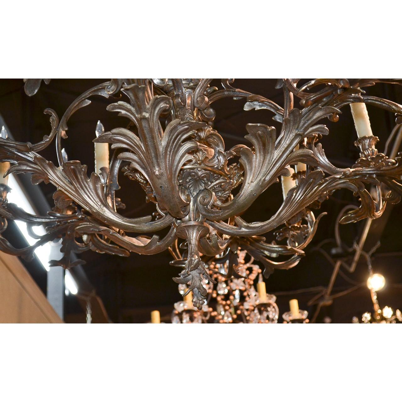 Very fine quality and magnificently crafted 19th century French Rococo style silver on bronze chandelier, ornately decorated overall with boldly scrolled acanthus leaves, flower clusters, and caryatid busts. The centre stem adorned with a tapered