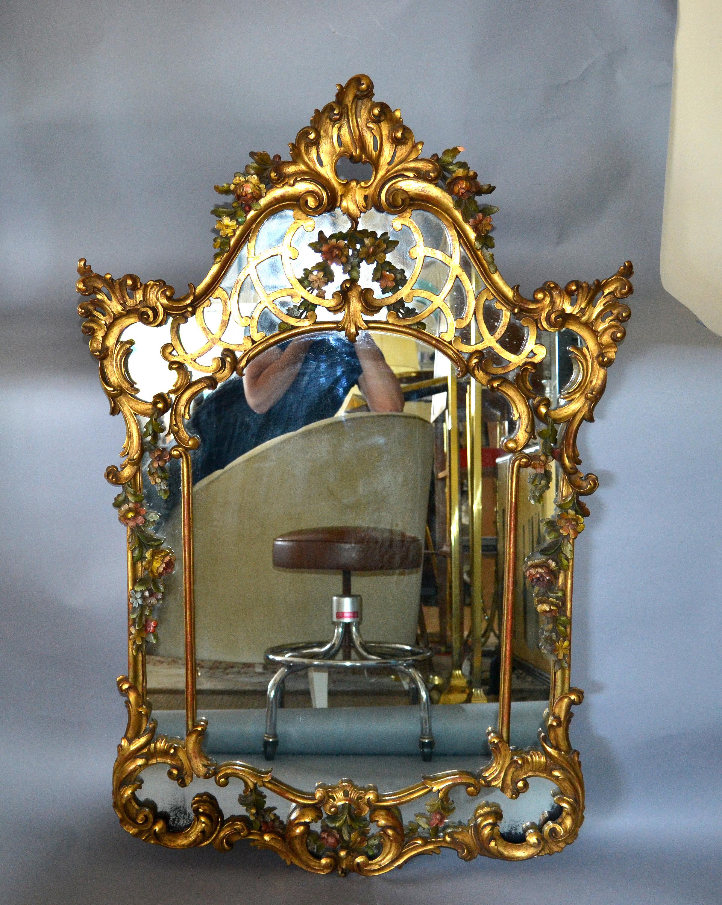19th century French Rococo style gilt wall mirror hand carved wood with flowers and wreaths.
This mirror is in original vintage condition.
 