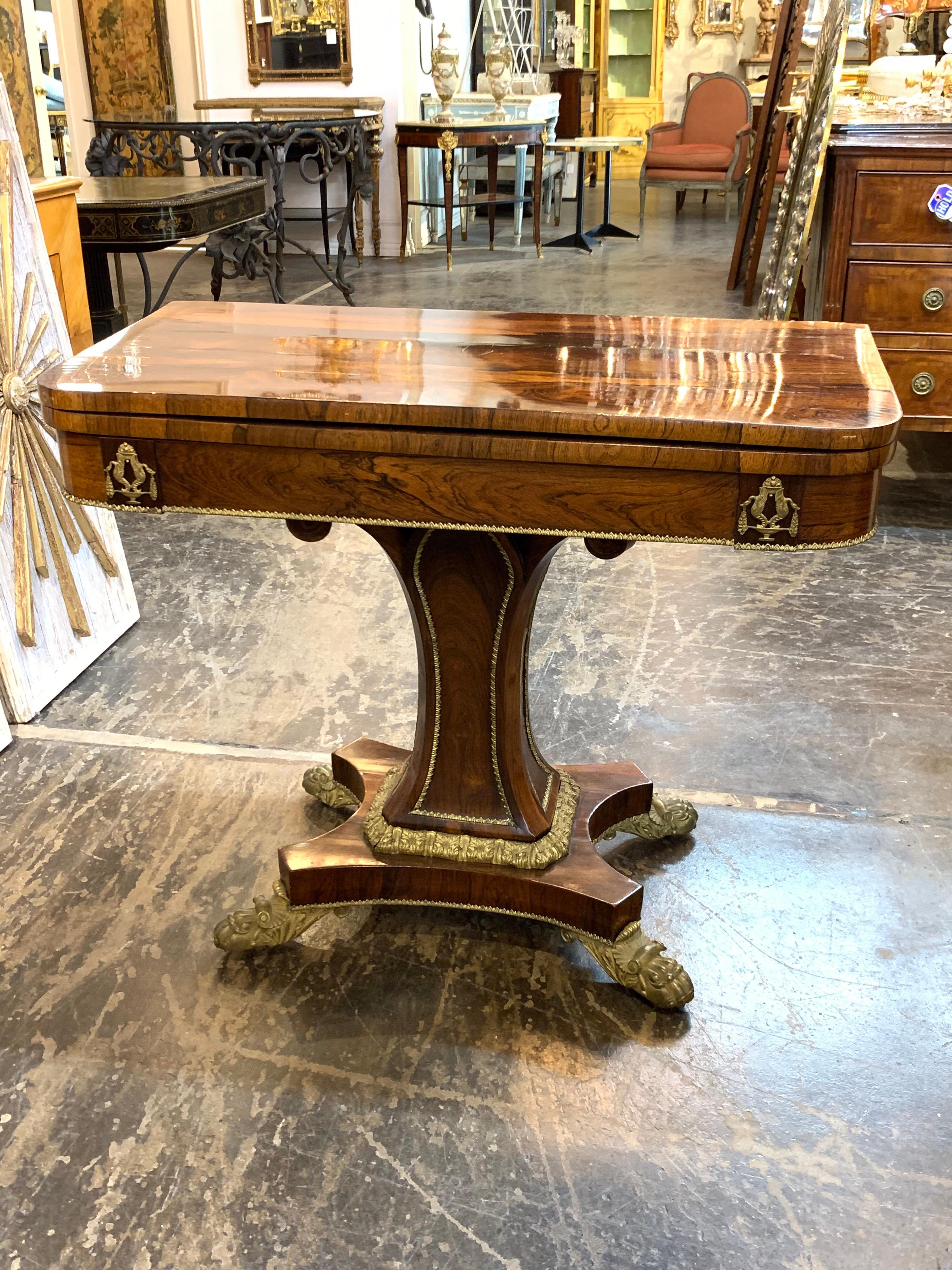 Exceptional 19th century French rosewood game table with bronze mounts. The table opens up to reveal a leather top. Beautiful wood grain and finish. So elegant!